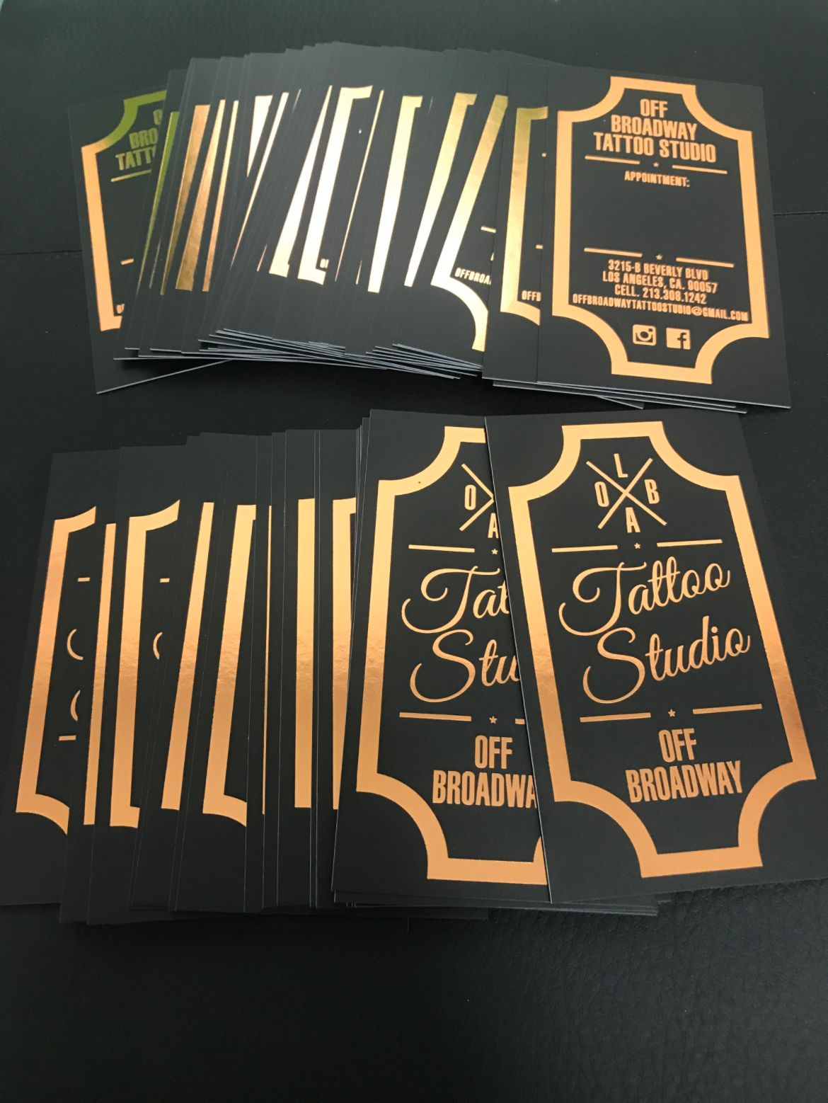 Black and gold business cards for a tattoo studio