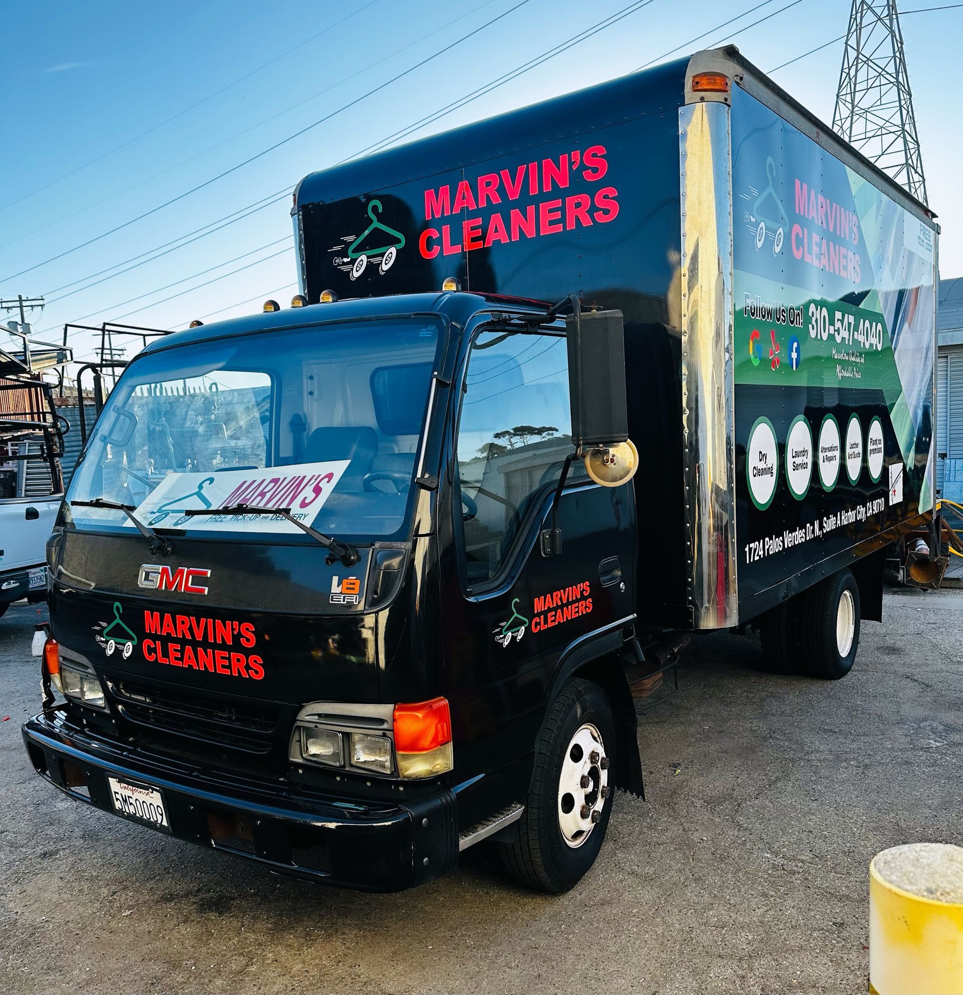 A marvin 's cleaners truck is parked in a parking lot
