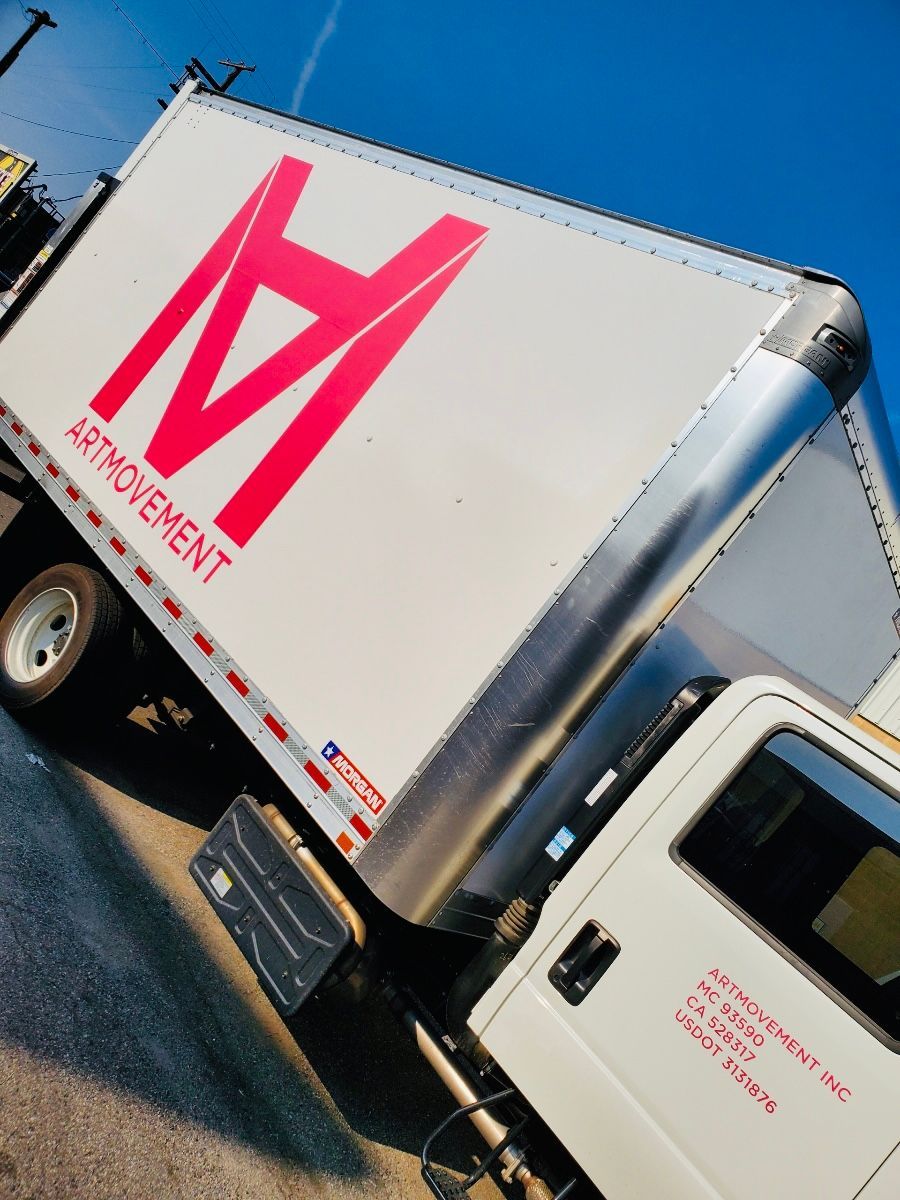 A white truck with the letter m on the side