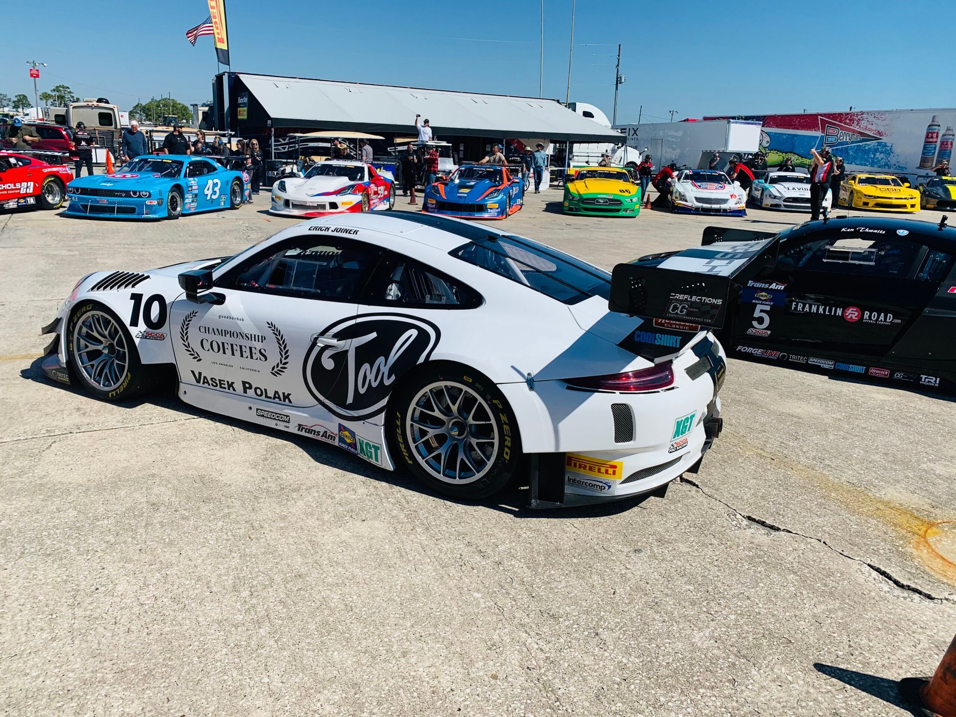 A race car with the number 10 on the side is parked in a parking lot.