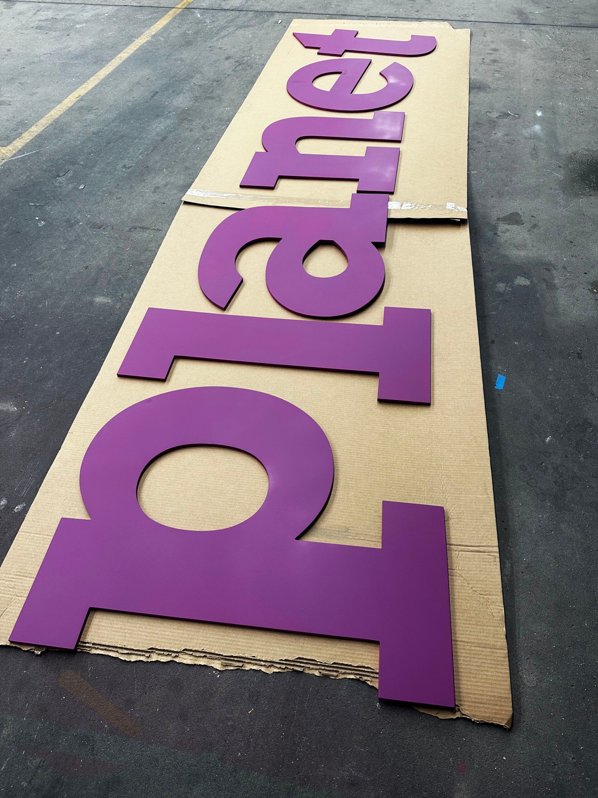 Purple planet letters on a cardboard box