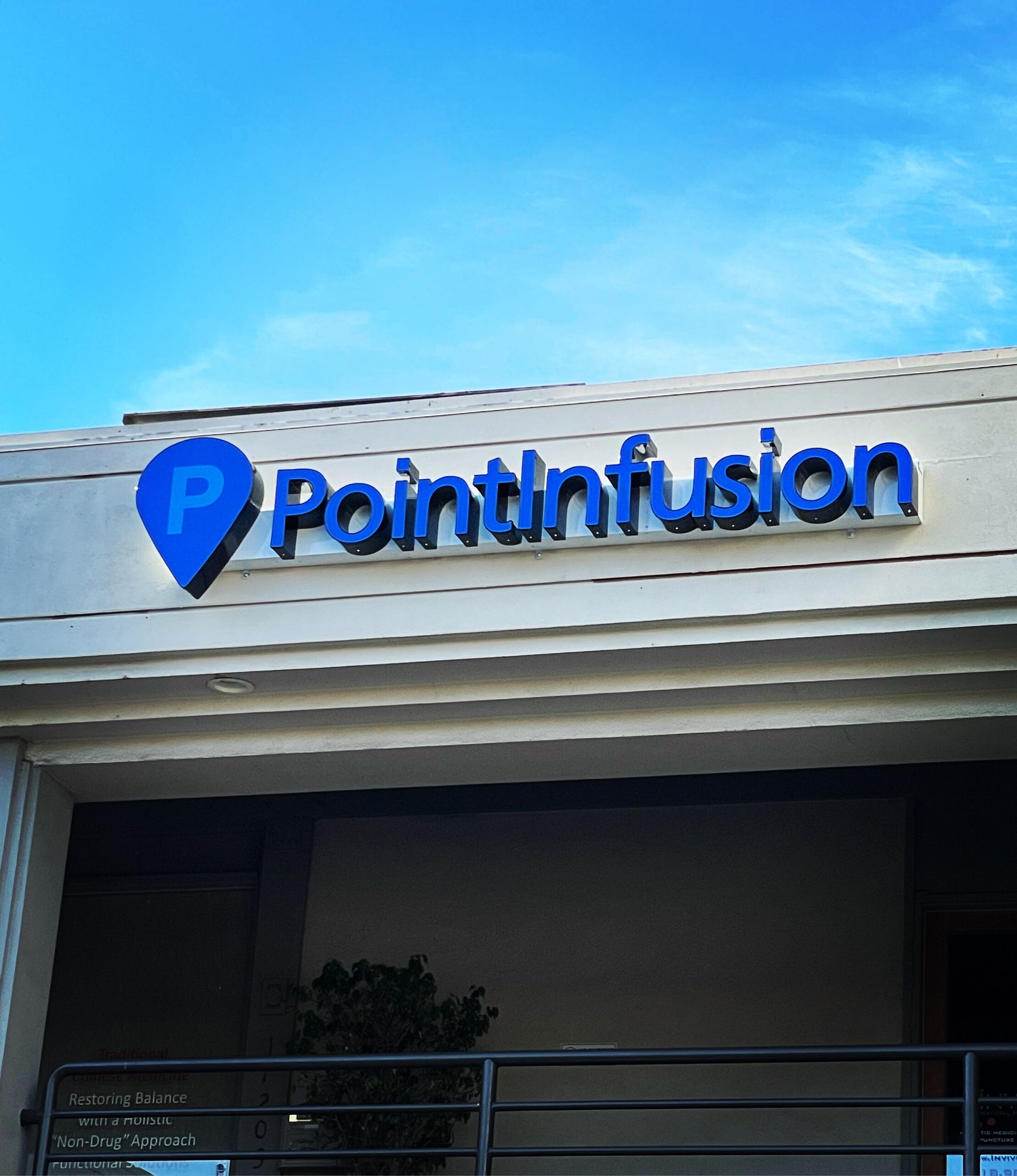 A building with a blue sign that says pointinfusion