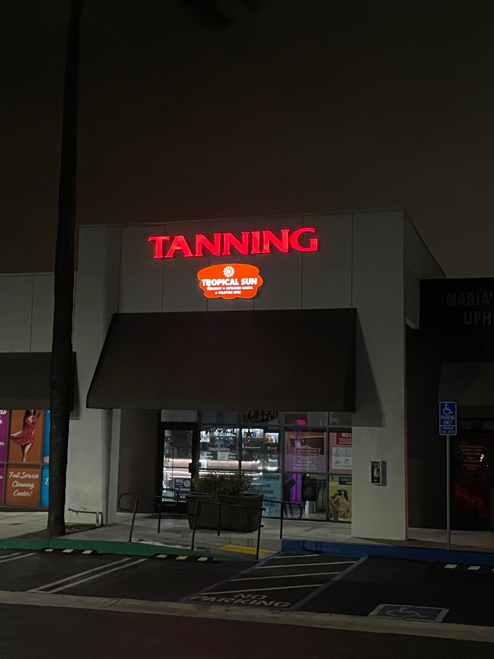 A tanning salon is lit up at night
