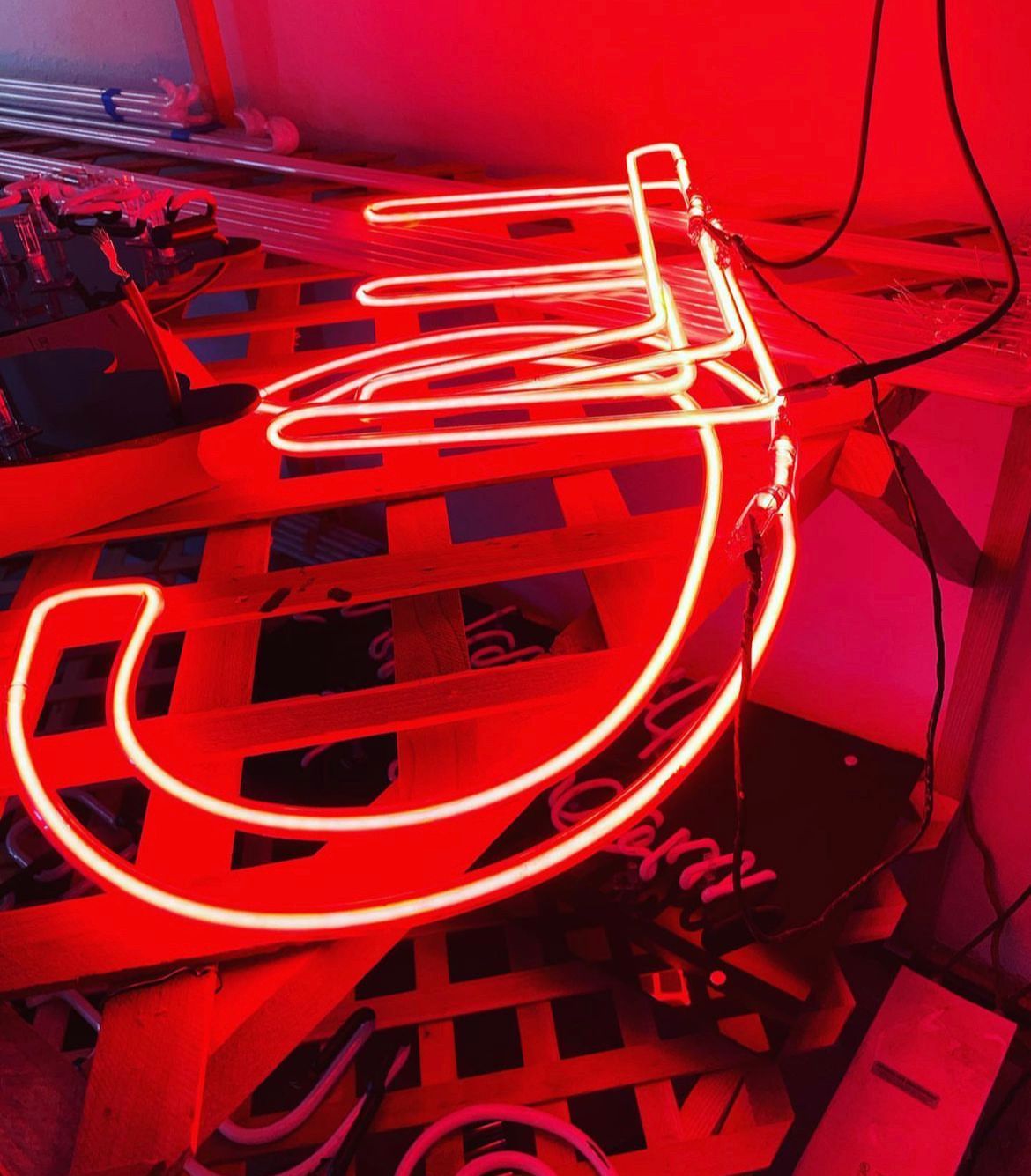A neon sign with the letter j on it