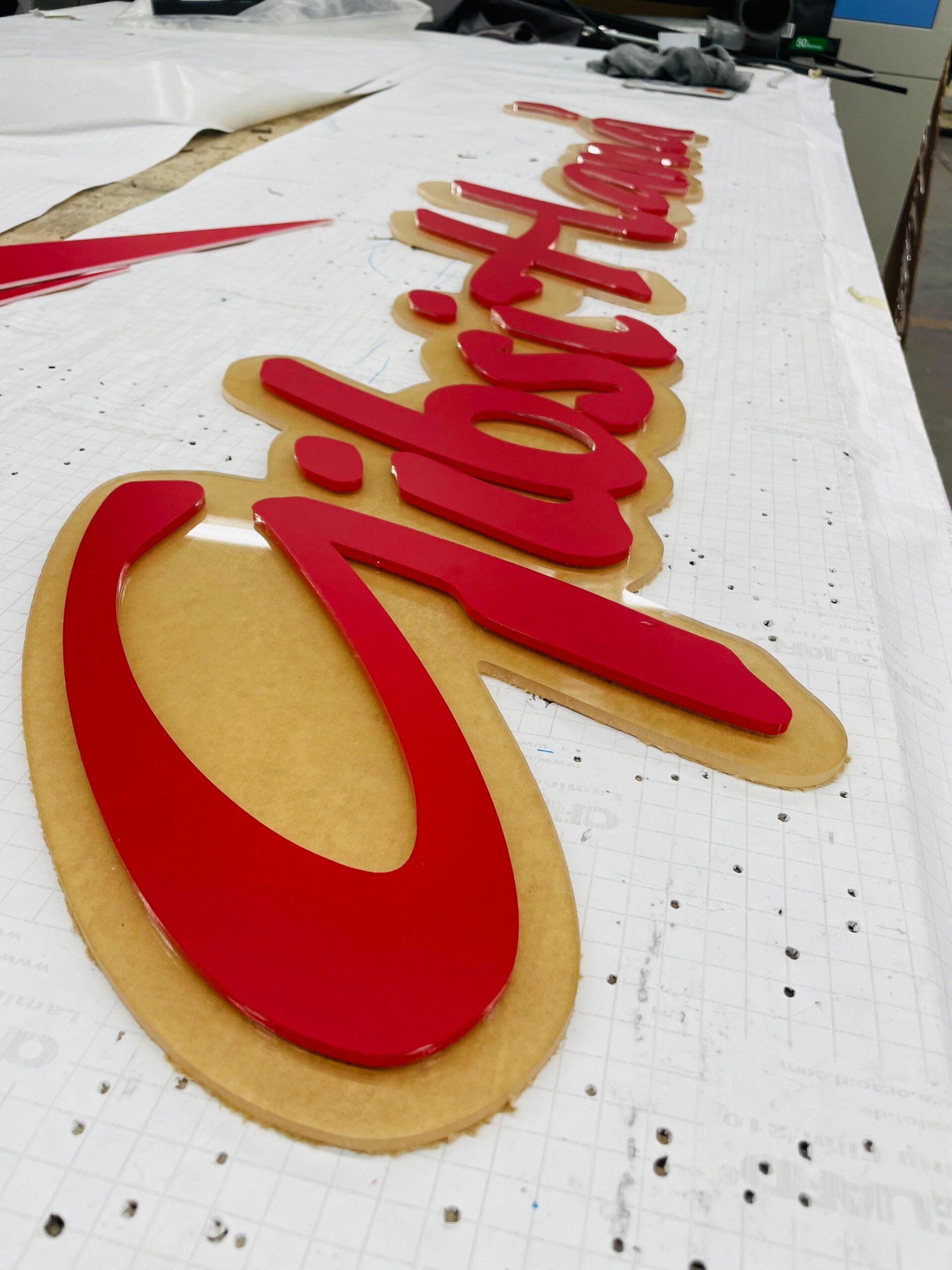 A red and gold sign that says ' christmas ' on it