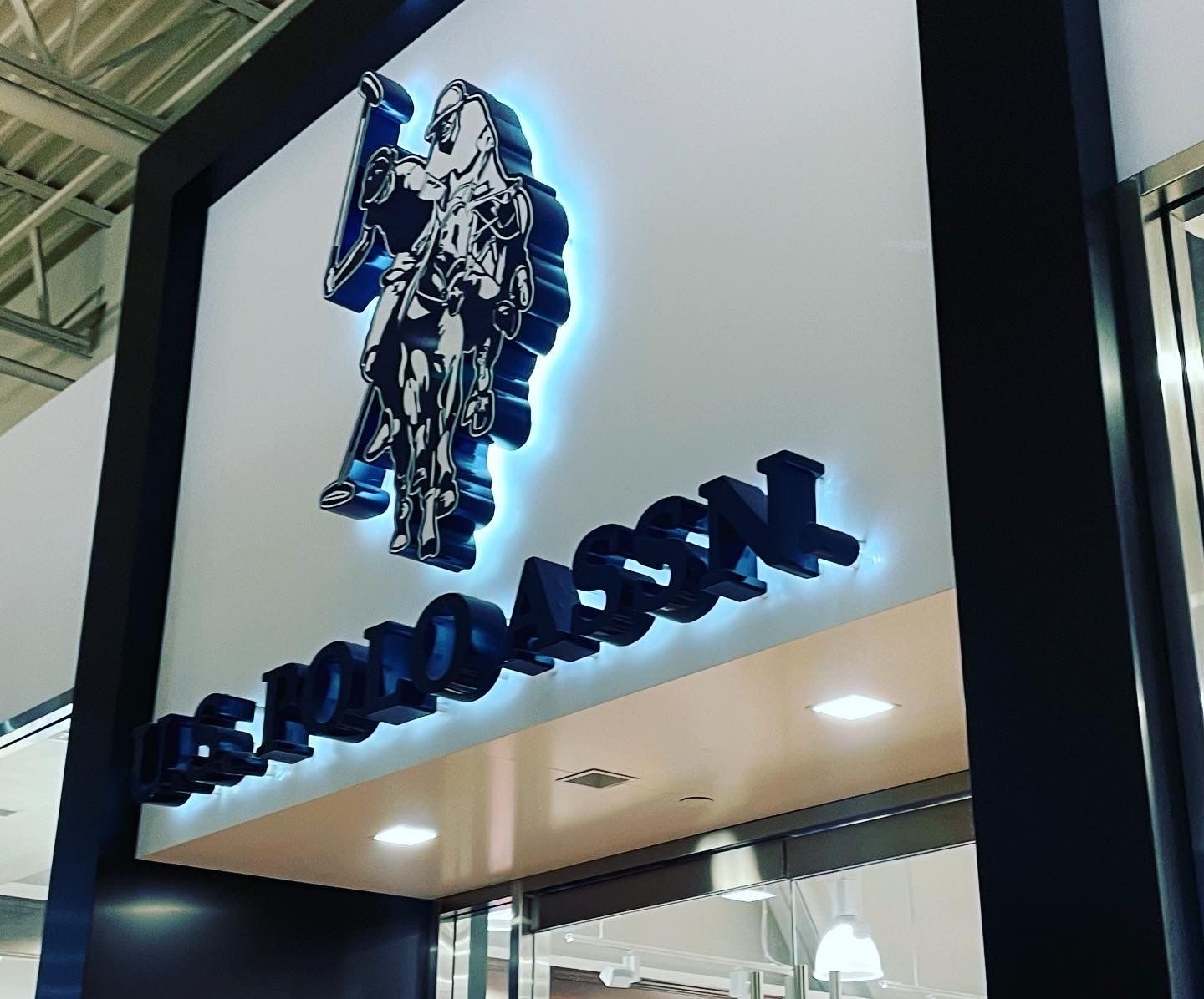 A sign for us polo assn shows a man holding a flag