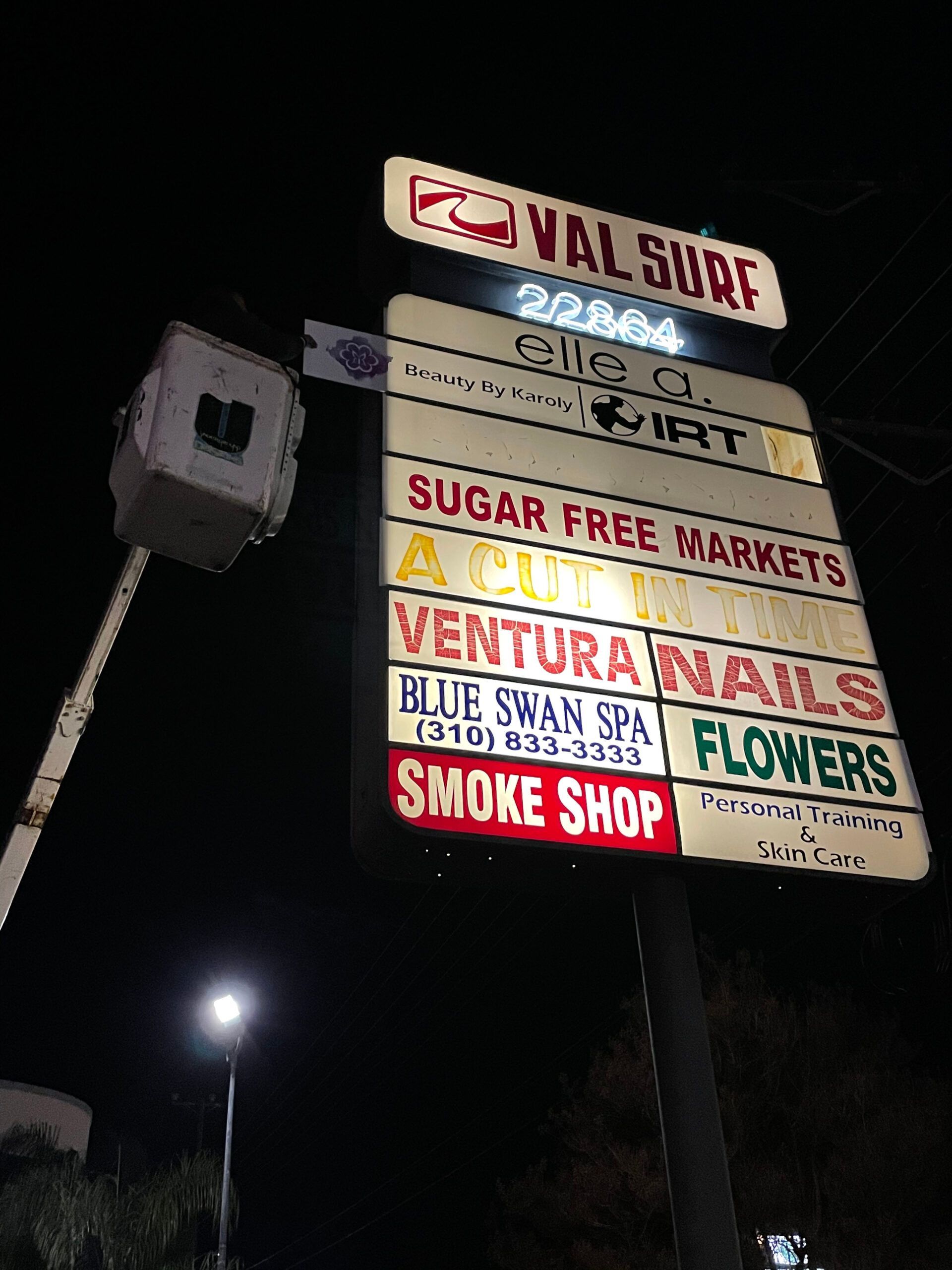 A sign for val surf is lit up at night