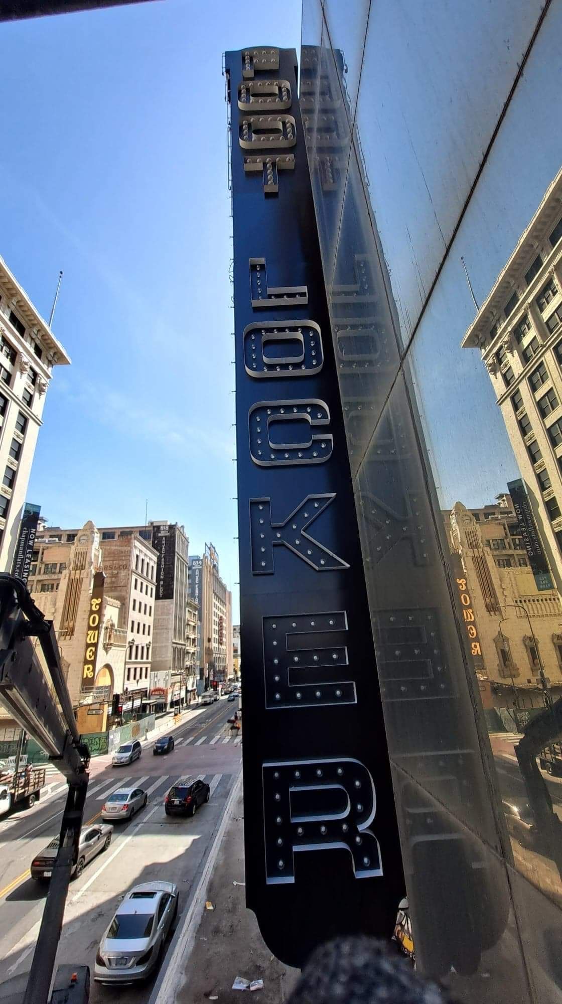 A tall vertical sign reading