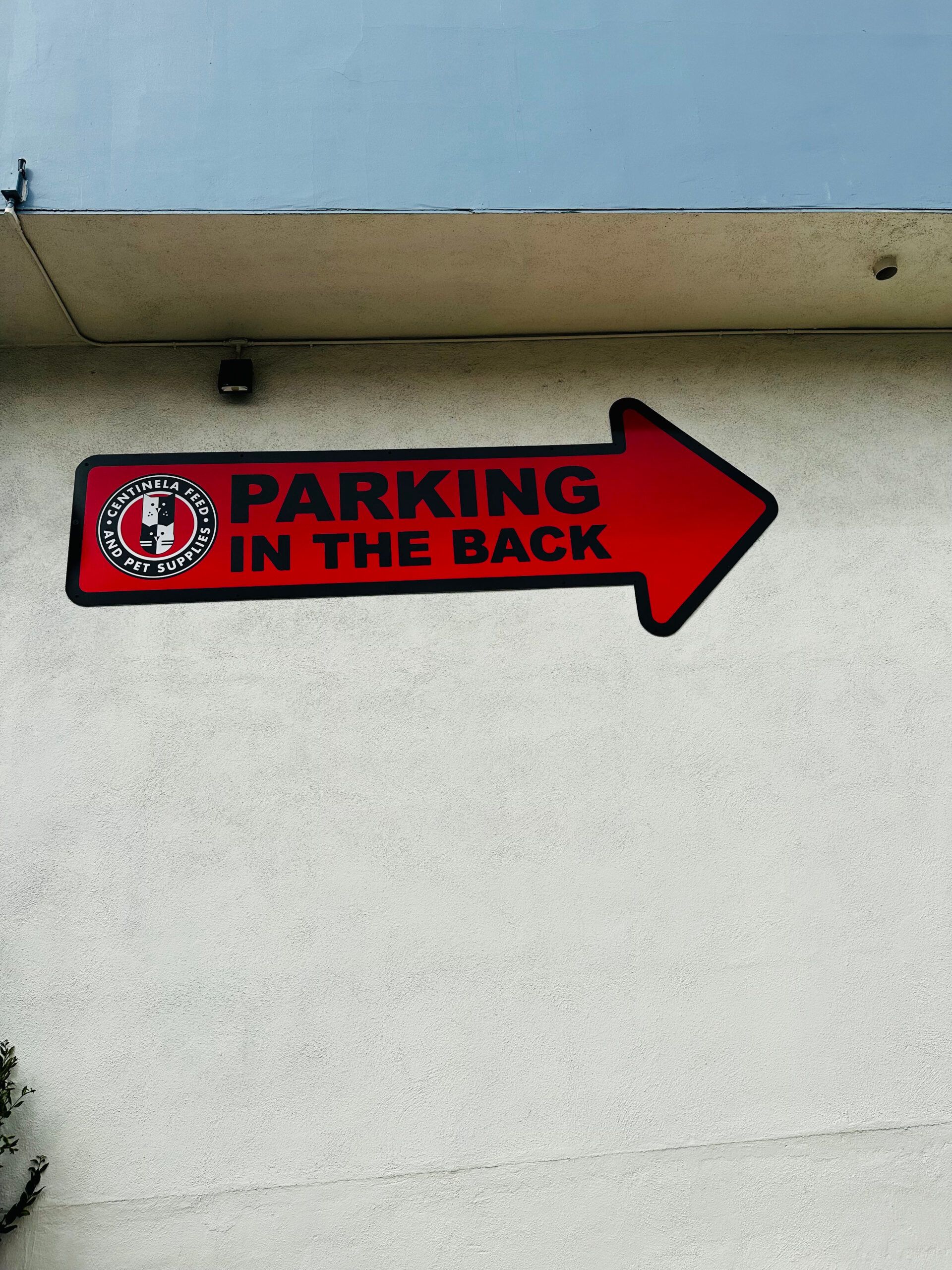 A red arrow pointing to the right says parking in the back