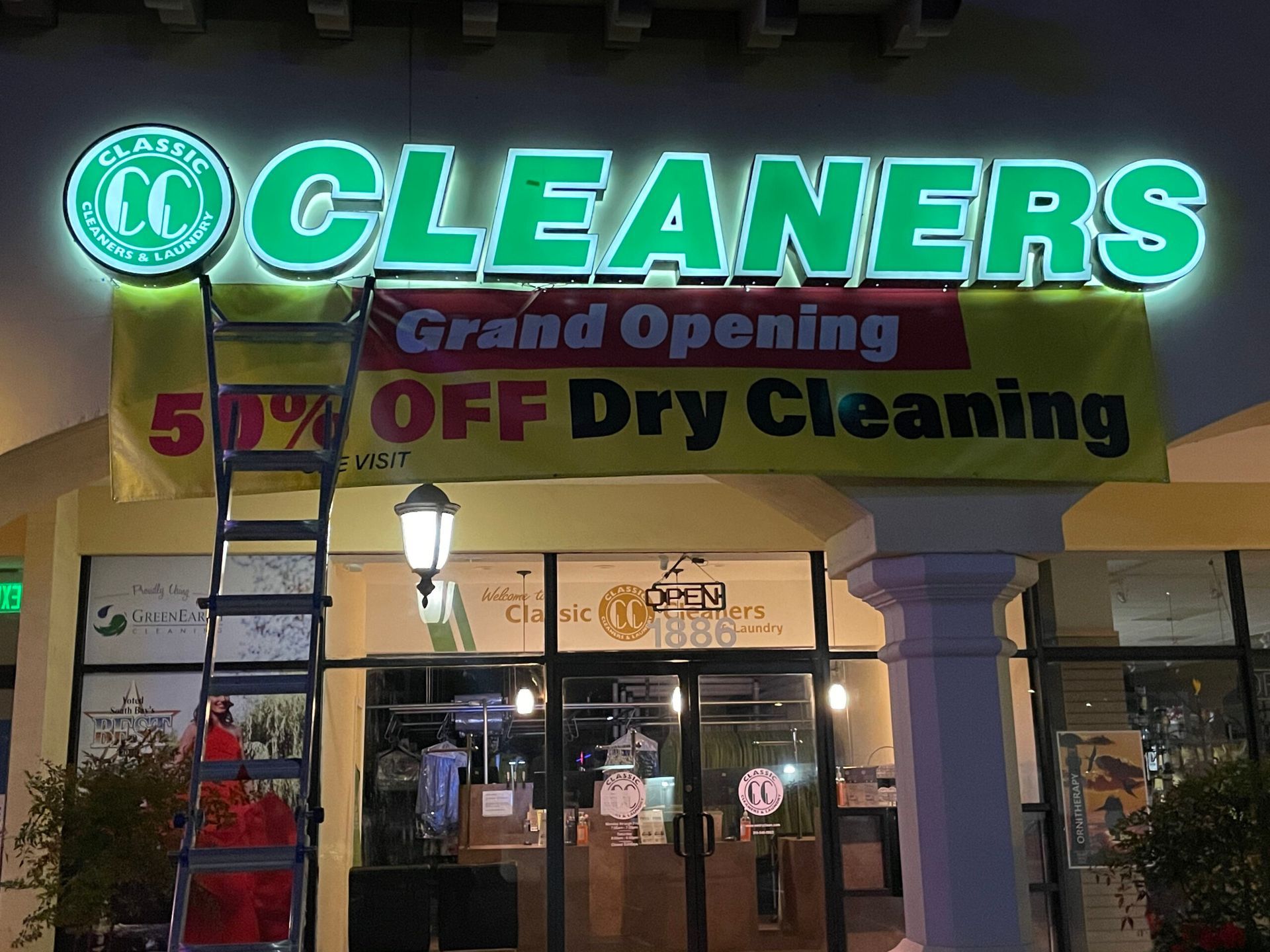 Cleaners grand opening 50 % off dry cleaning sign