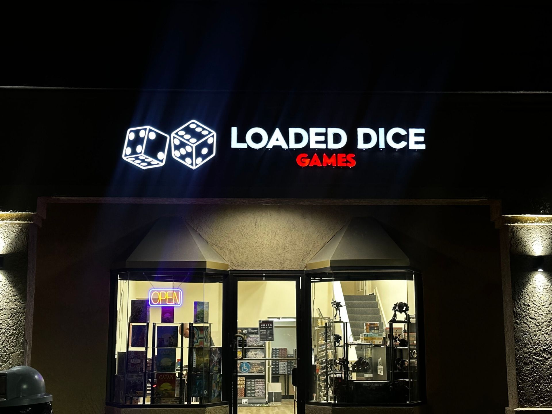 A store front with a sign that says loaded dice games