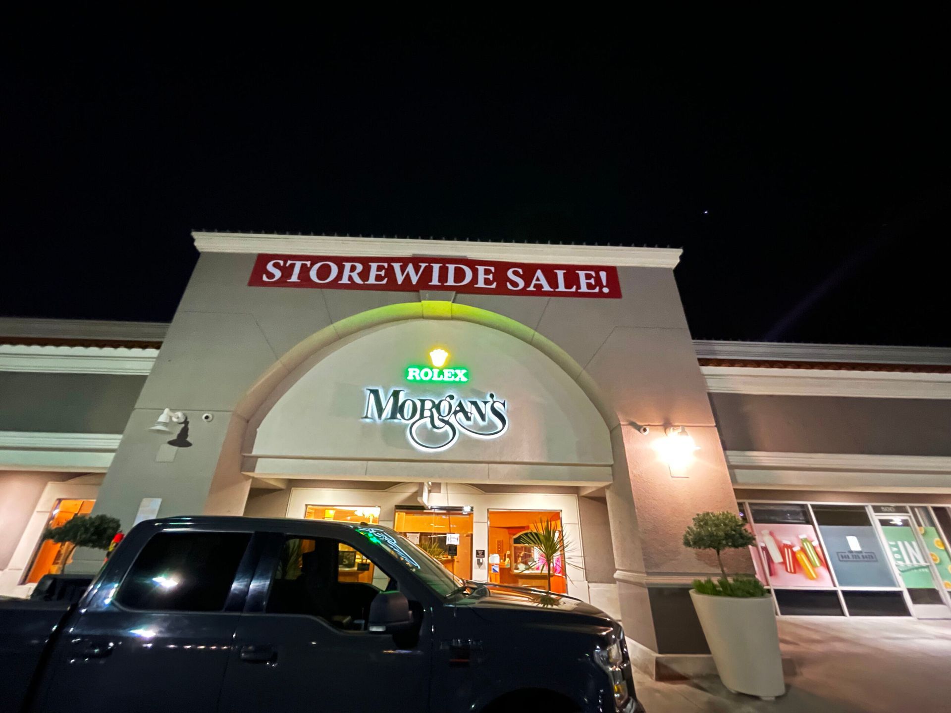 A truck is parked in front of a store called murphy 's