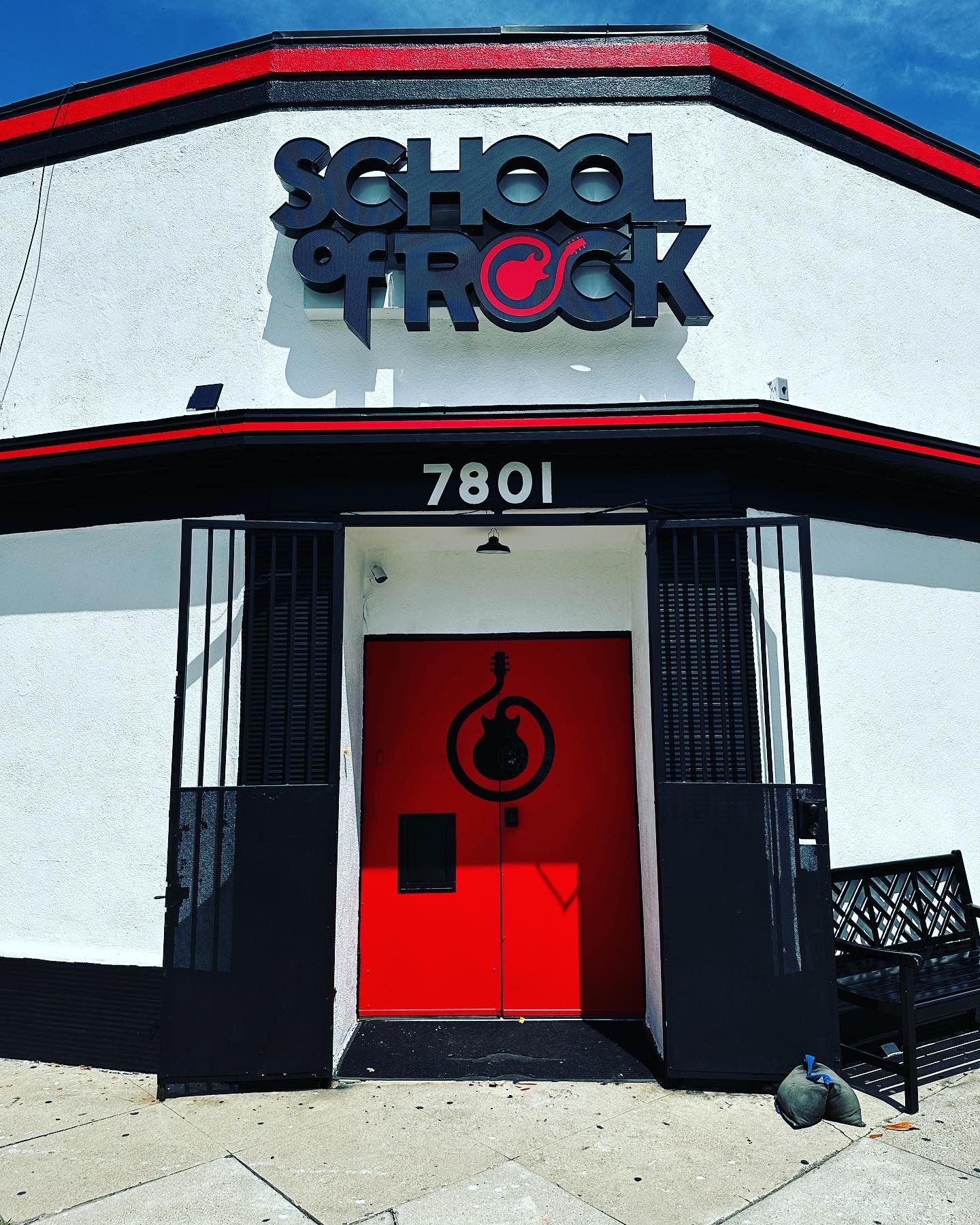 A school of rock building with a red door