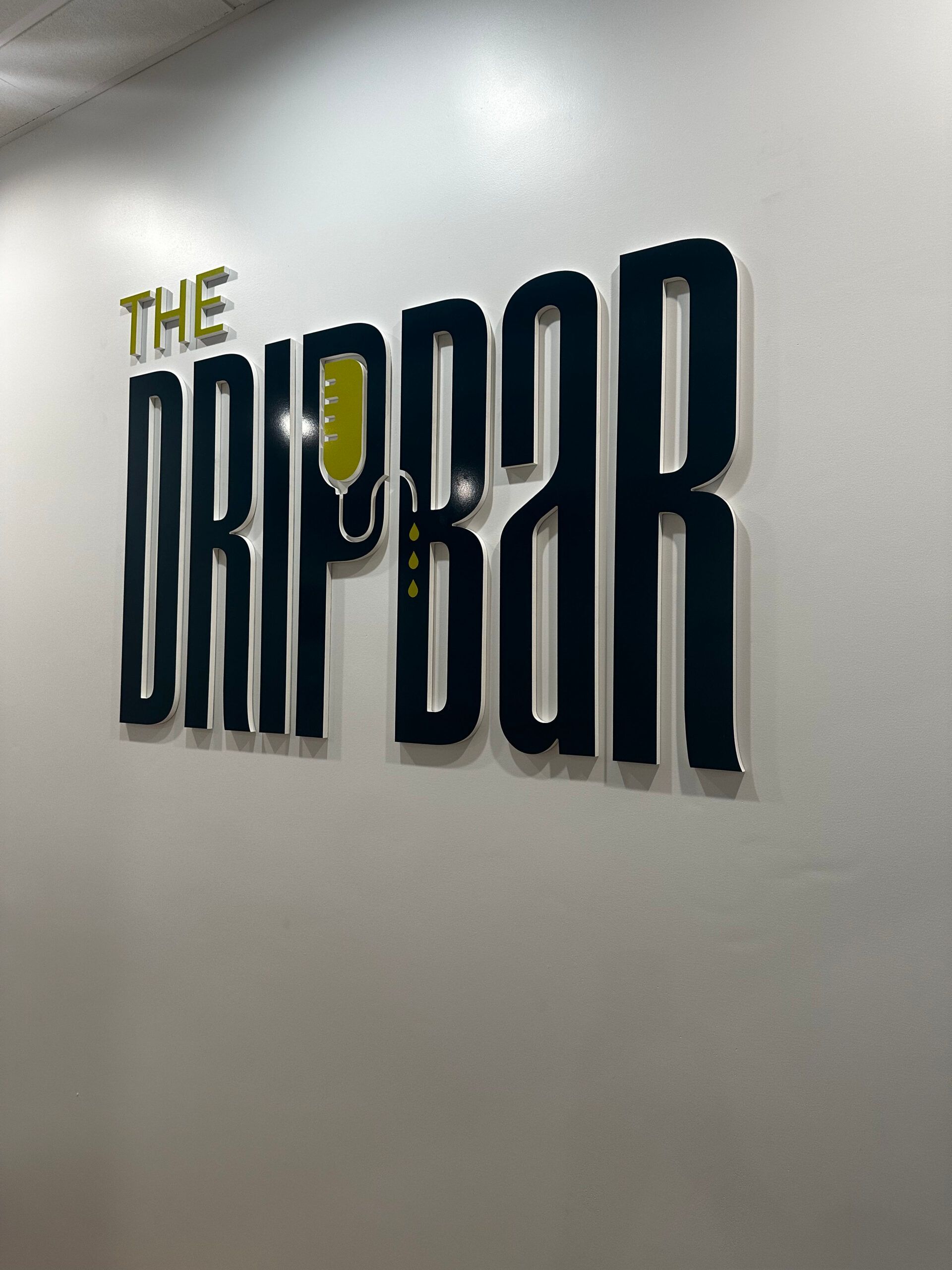 The word drip bar is on a white wall