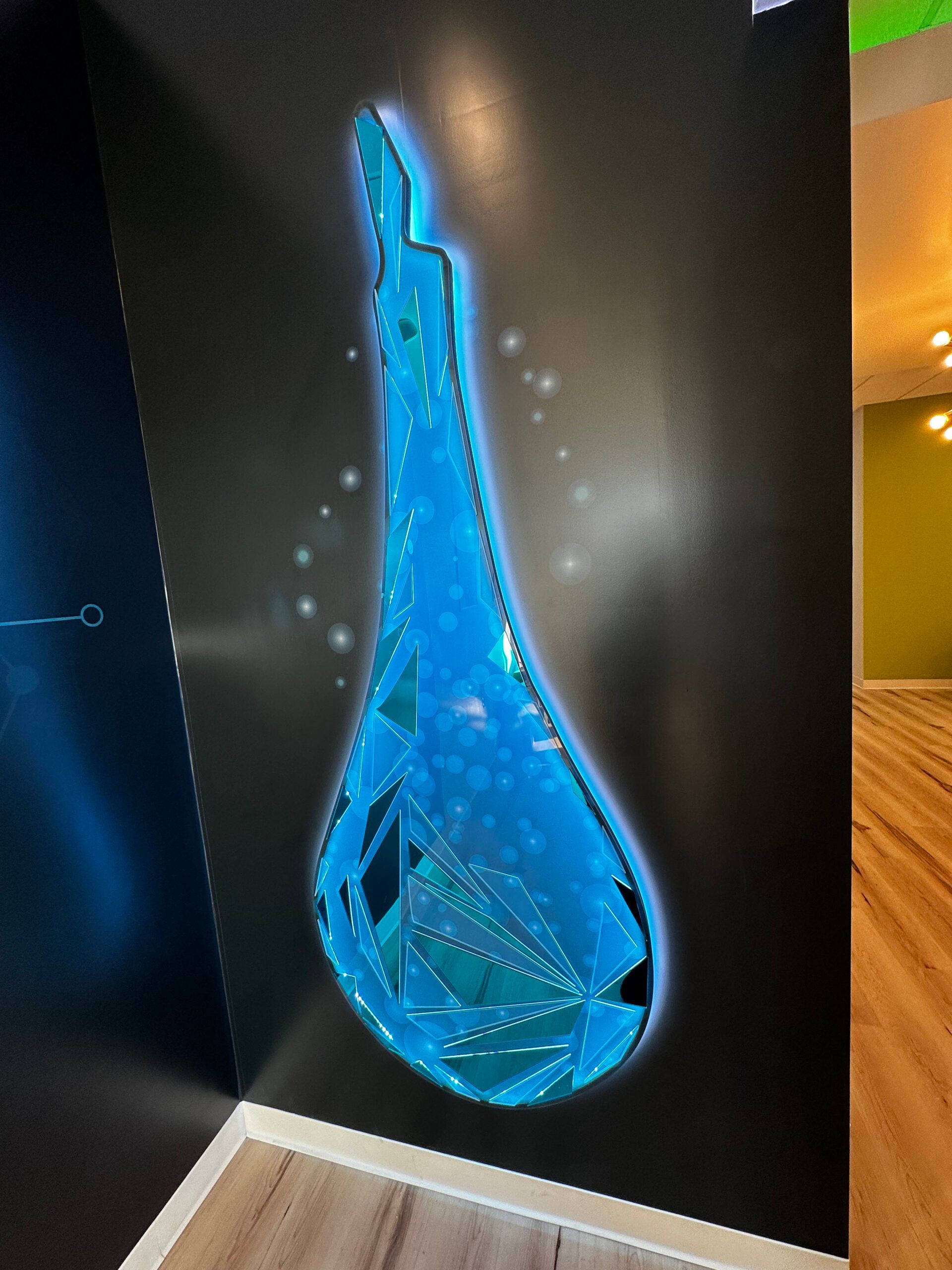 A painting of a drop of water on a wall