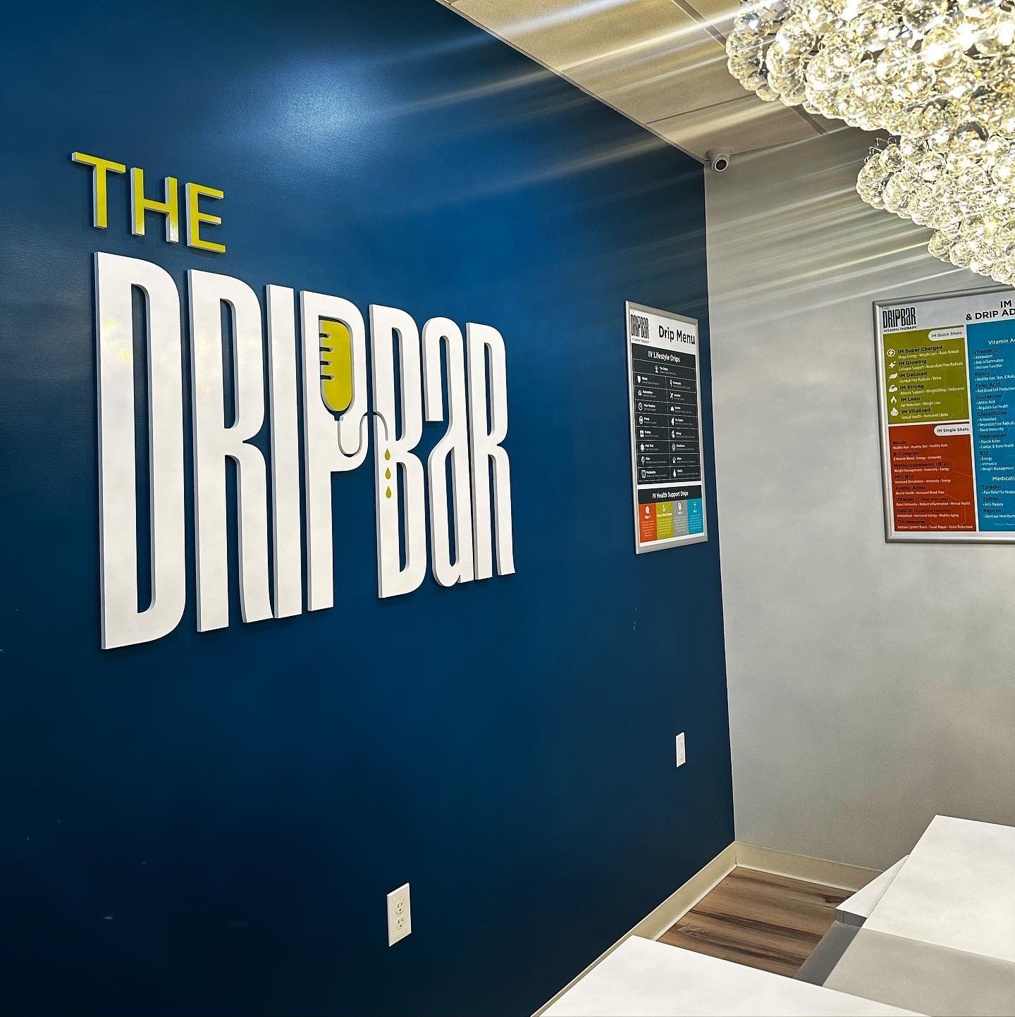 A blue wall with the words the drip bar on it