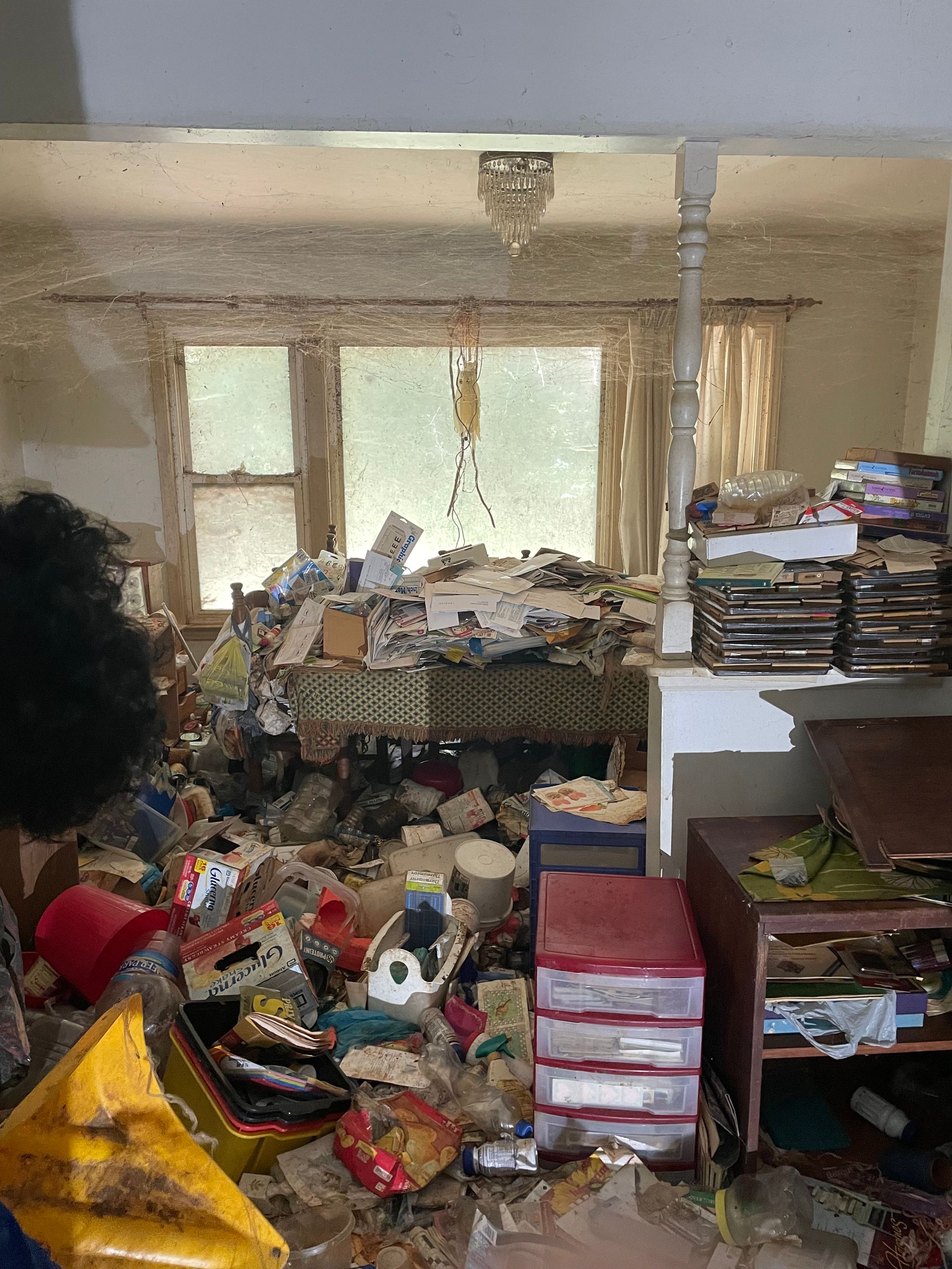A living room filled with lots of trash and junk.