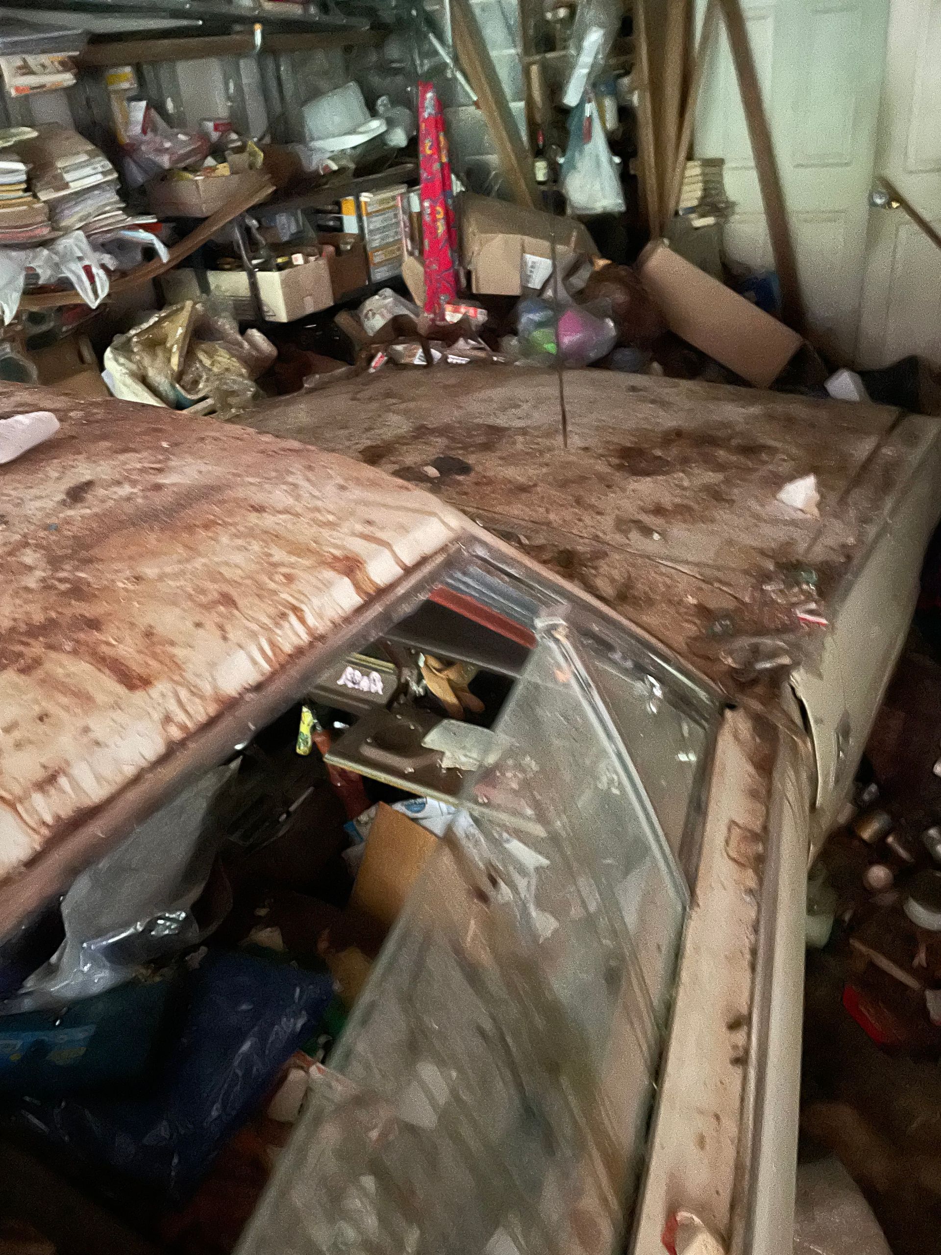 A very messy room with a lot of junk on the floor