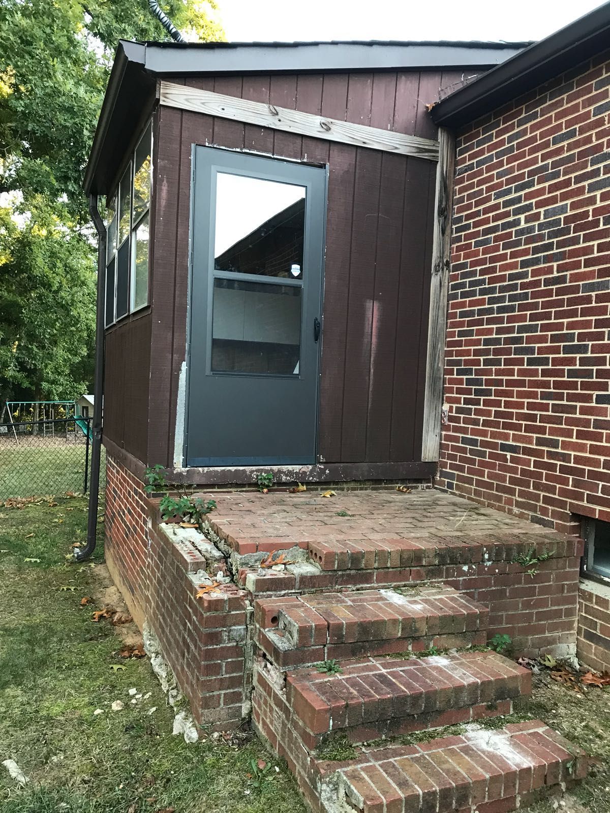 There is a brick building with stairs leading up to it.