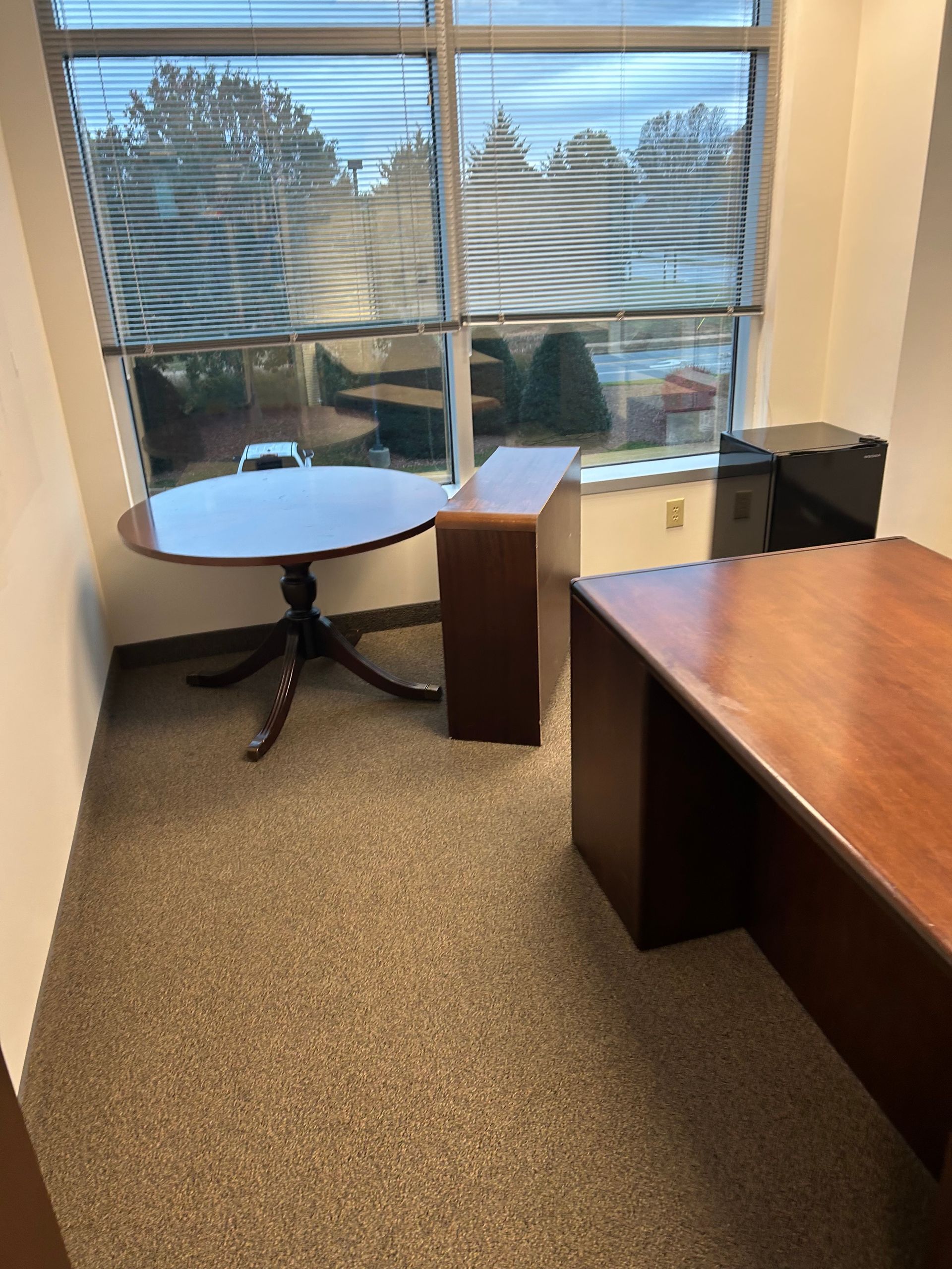 A small office with a table and a window