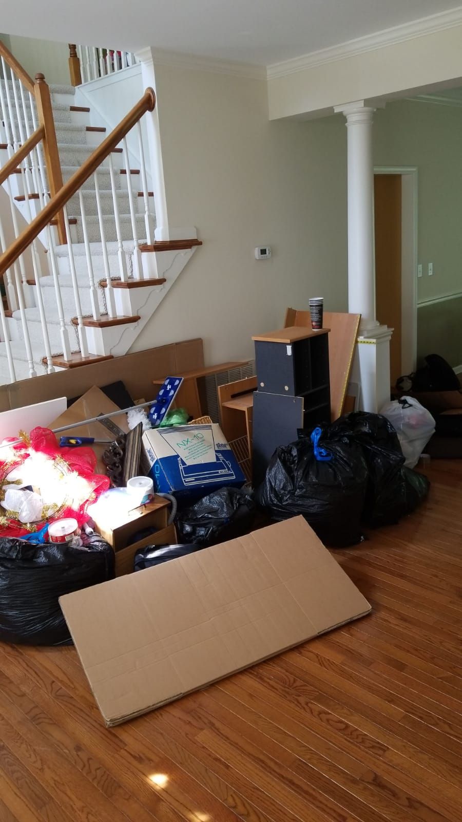 A living room filled with lots of furniture and trash bags.