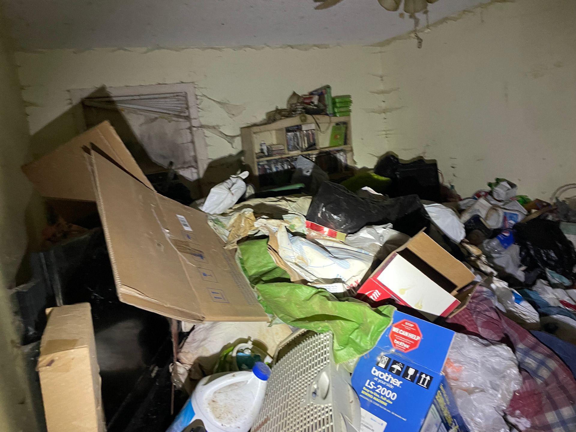 A room filled with lots of junk and boxes.