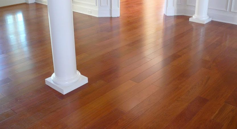 Glossy hardwood floor with white pillars.