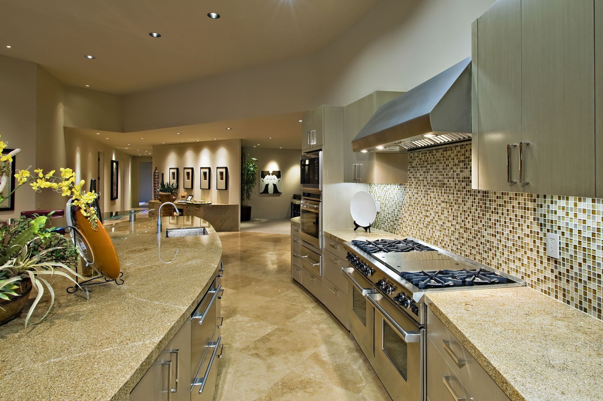 Modern kitchen with granite countertops, stainless steel appliances, and mosaic backsplash.