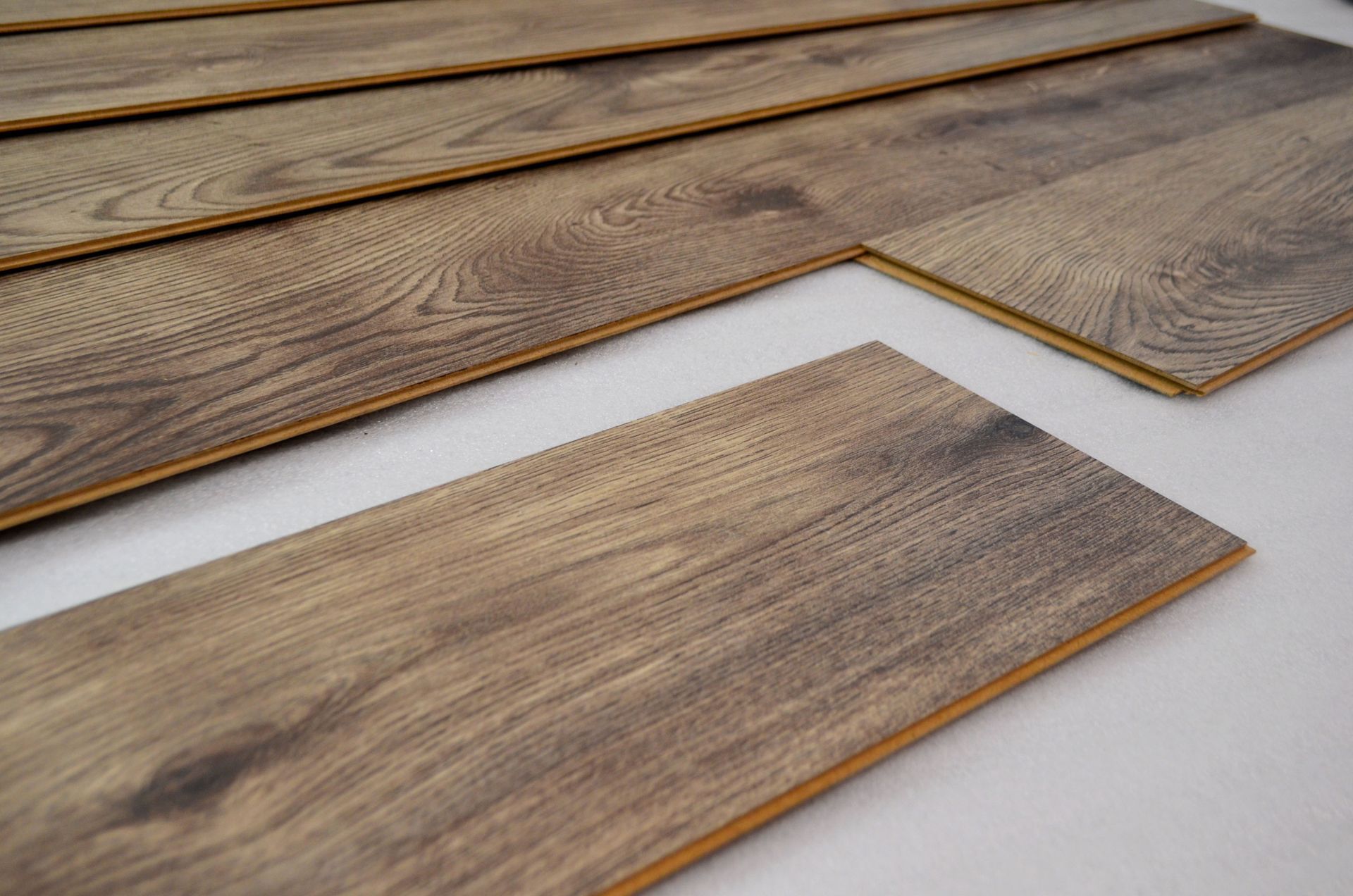 A bunch of wooden boards are laying on top of each other on a white surface.