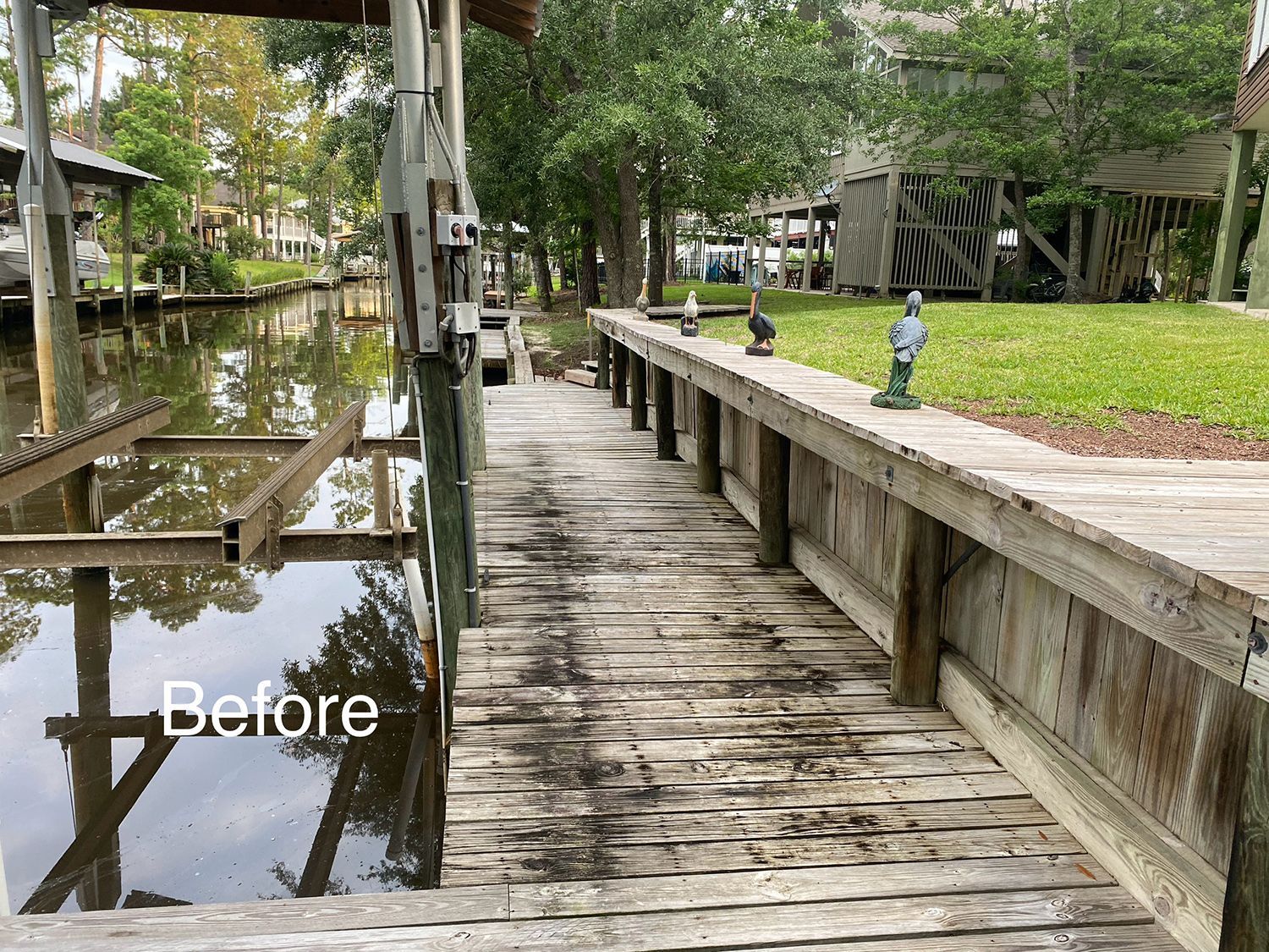 A before photo of a wooden dock next to a body of water