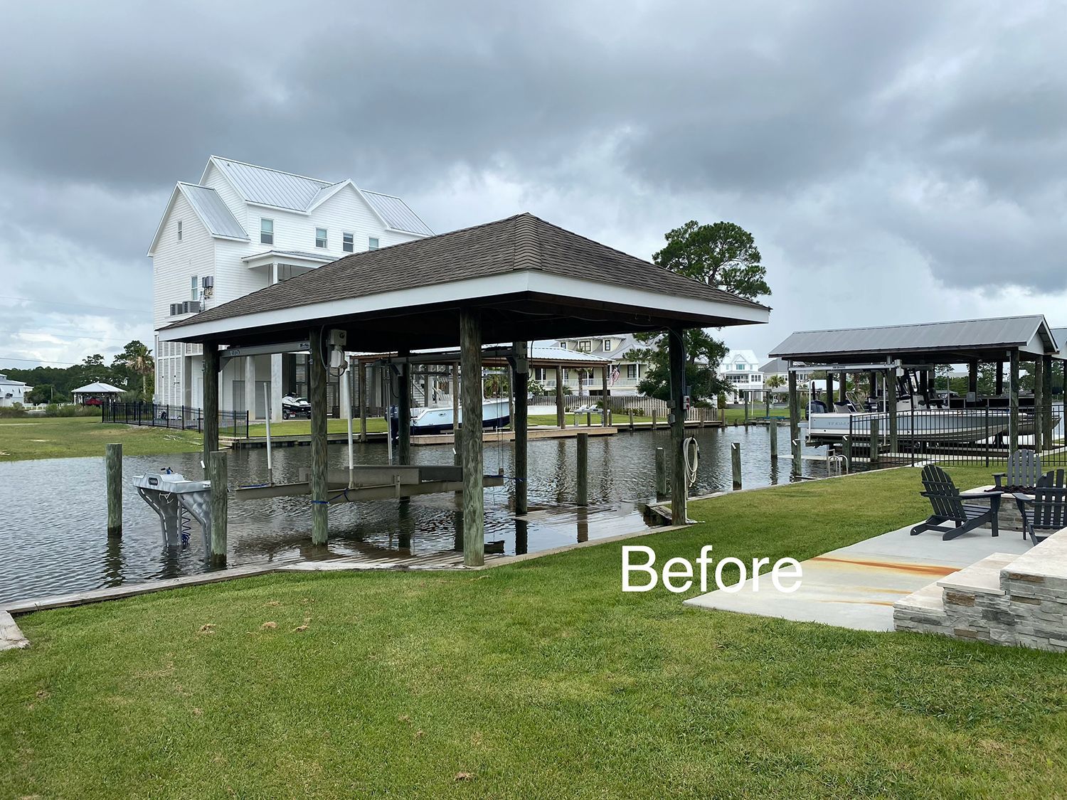 A before picture of a boat dock with a house in the background