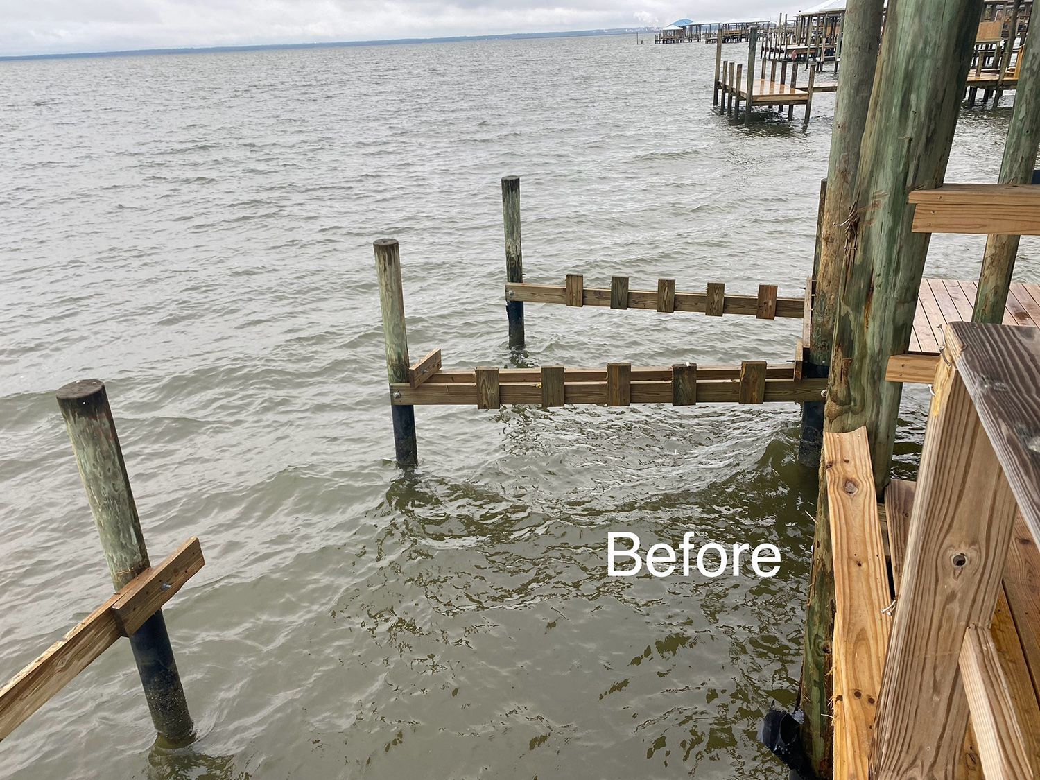 A before picture of a wooden dock in the water