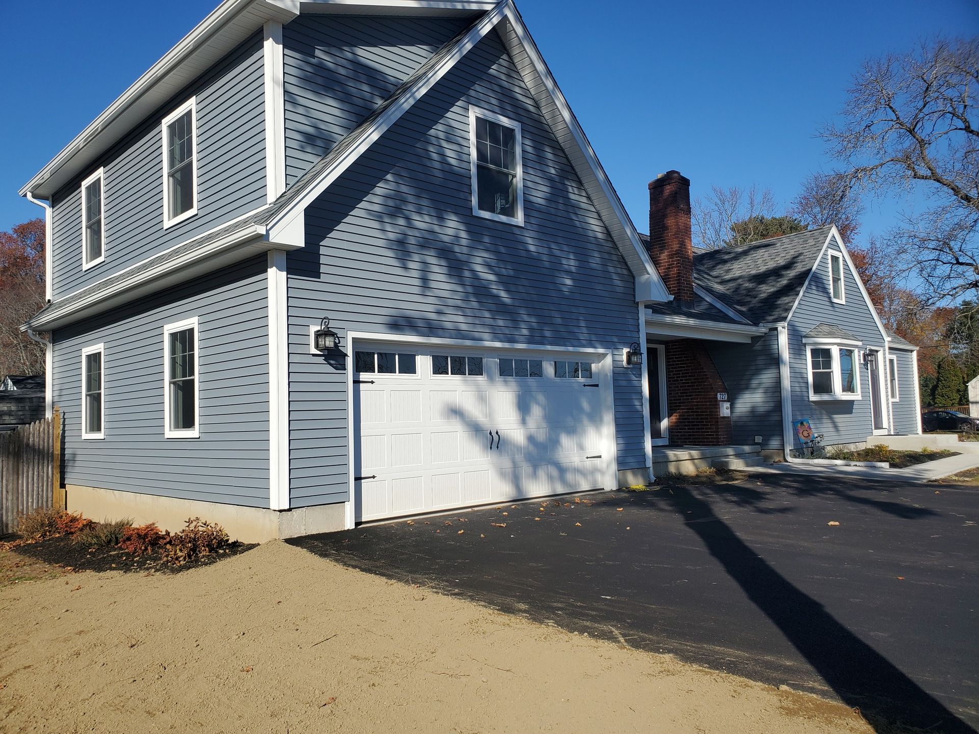 A gray house with a white garage door