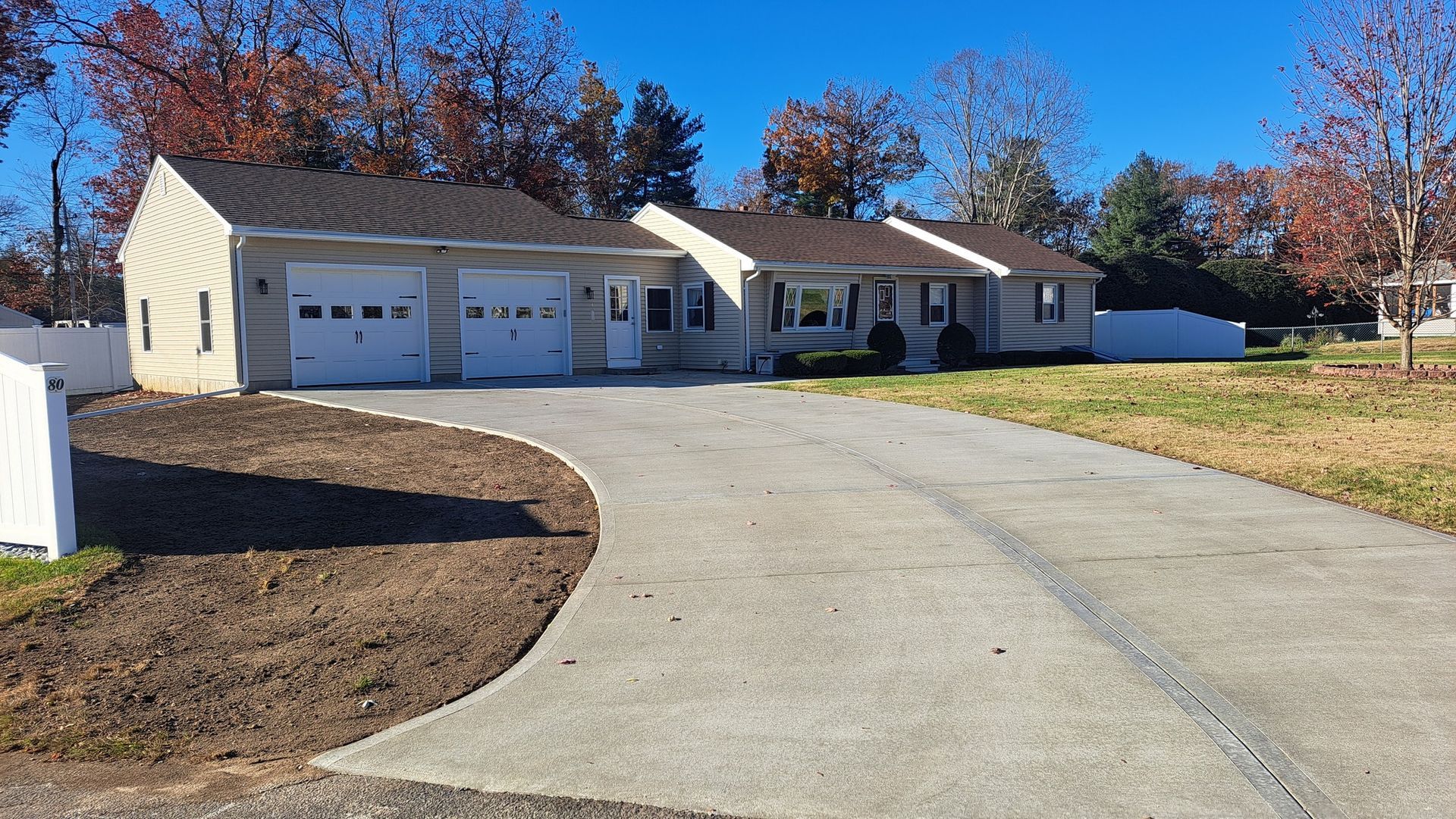 A house with a concrete driveway leading to it