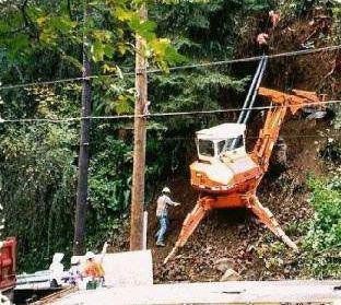 A large orange excavator is sitting on top of a hill.