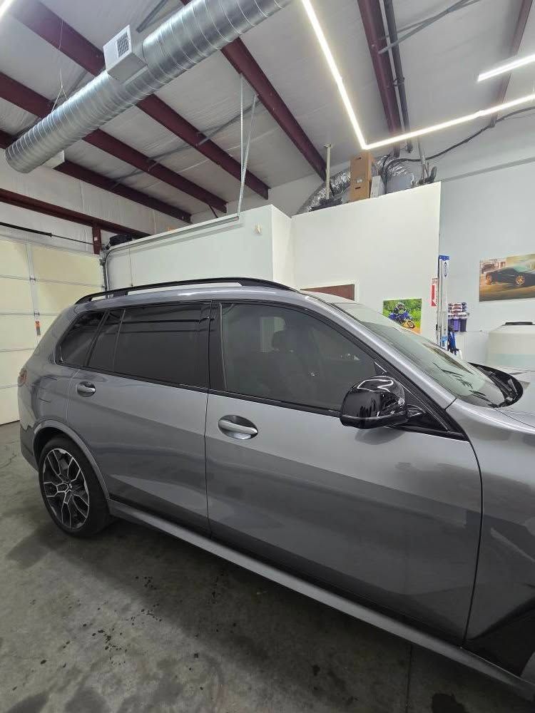 A gray car is parked in a garage.