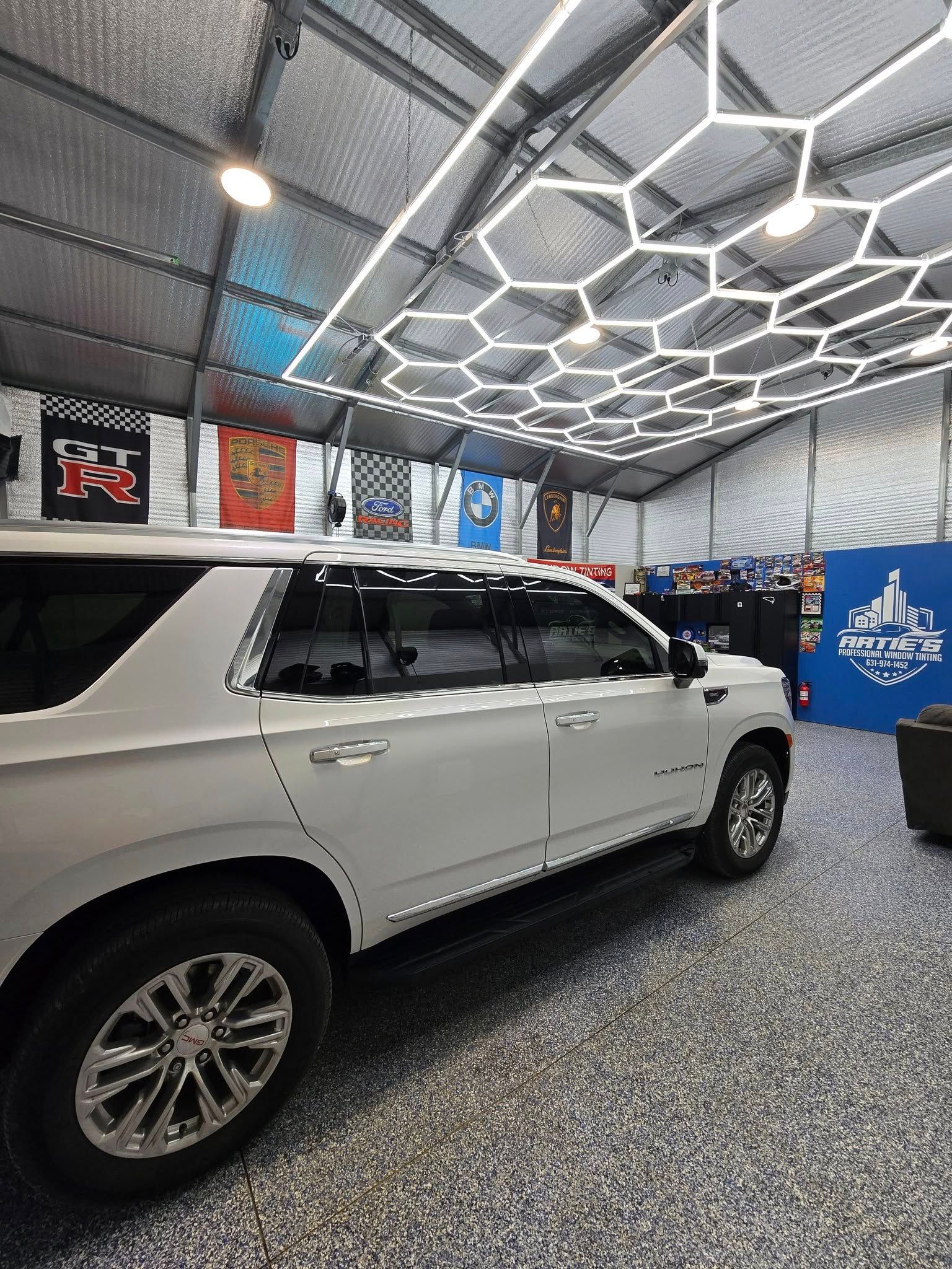 A white suv is parked inside of a building.