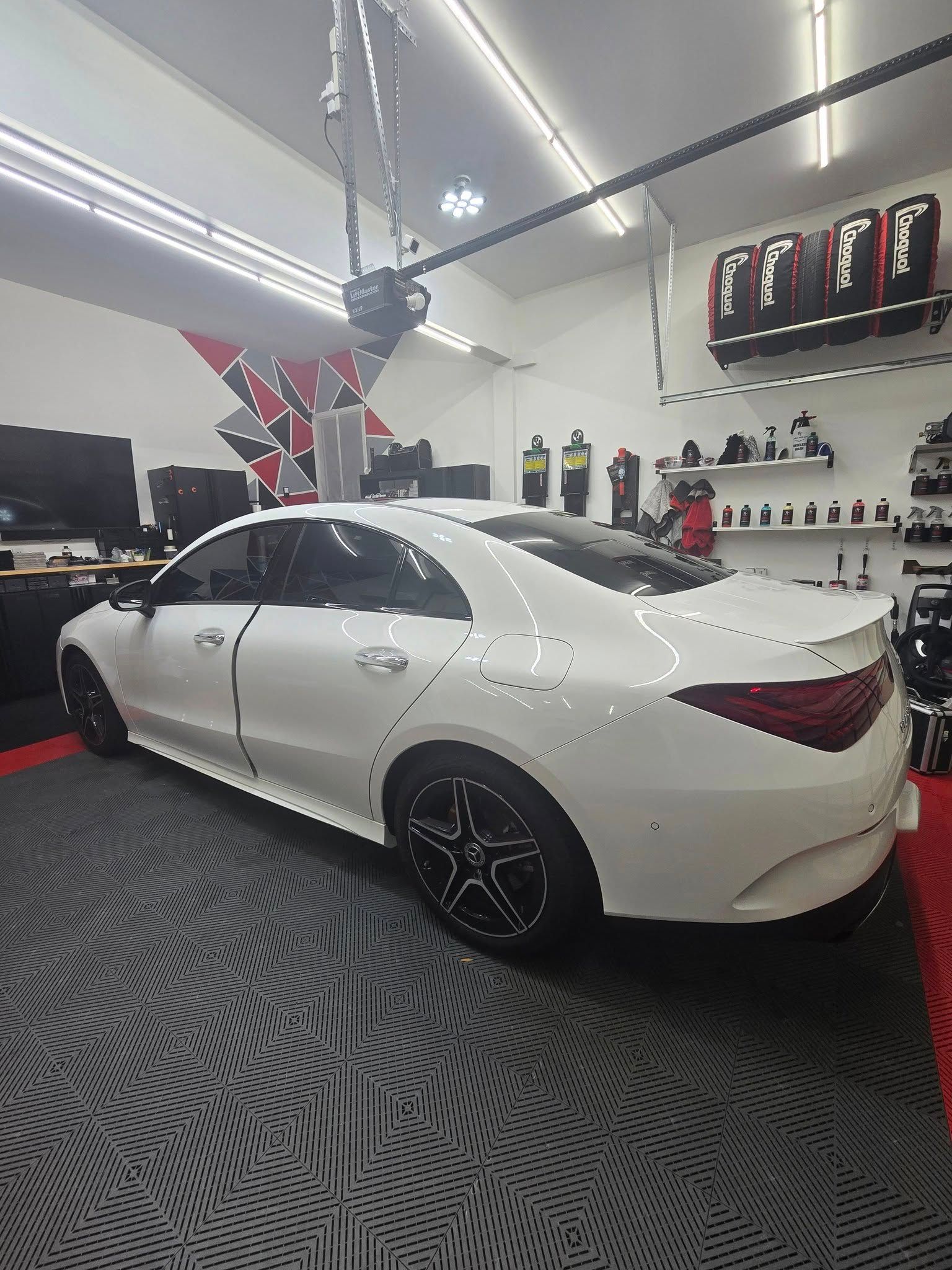 A white car is parked in a garage.