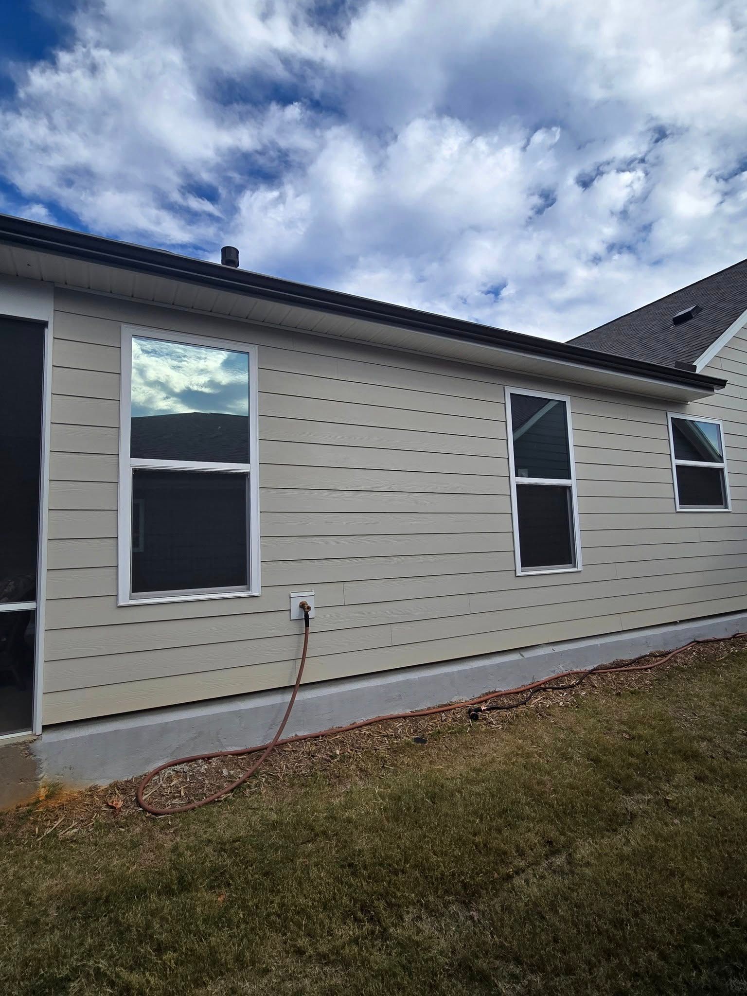 A house with a lot of windows on the side of it.