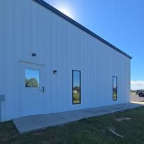 A white building with a lot of windows and a door.