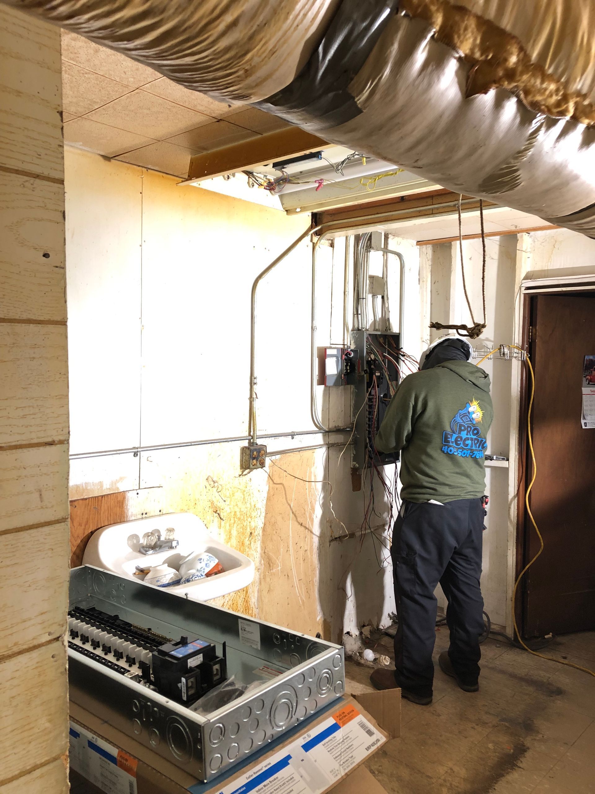 a man is working on a water heater in a room