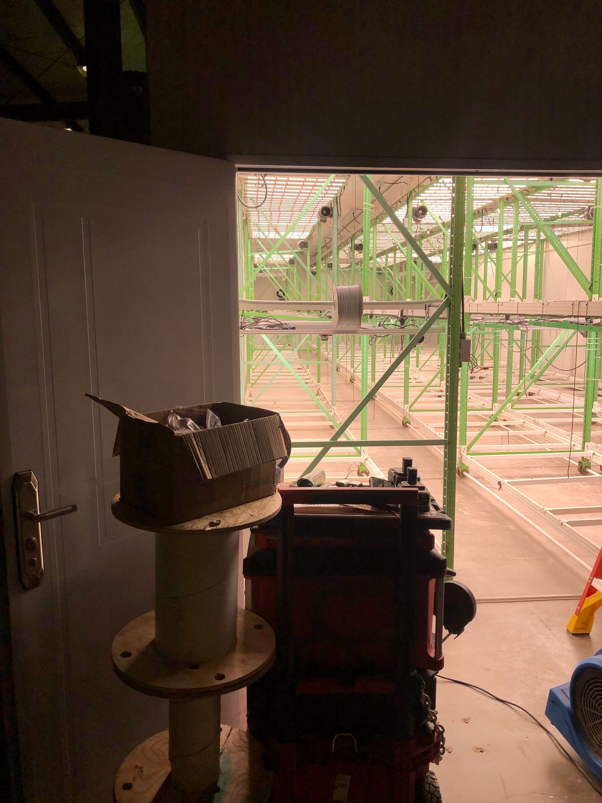 a box is sitting on top of a wooden spool in a dark room