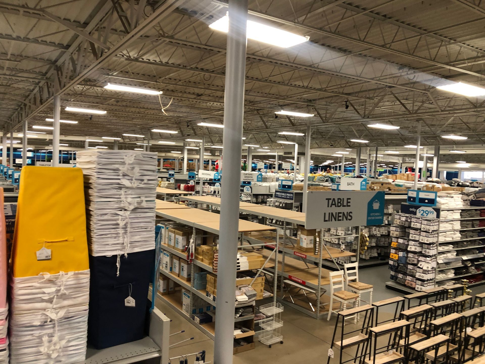 a large warehouse filled with lots of shelves and chairs