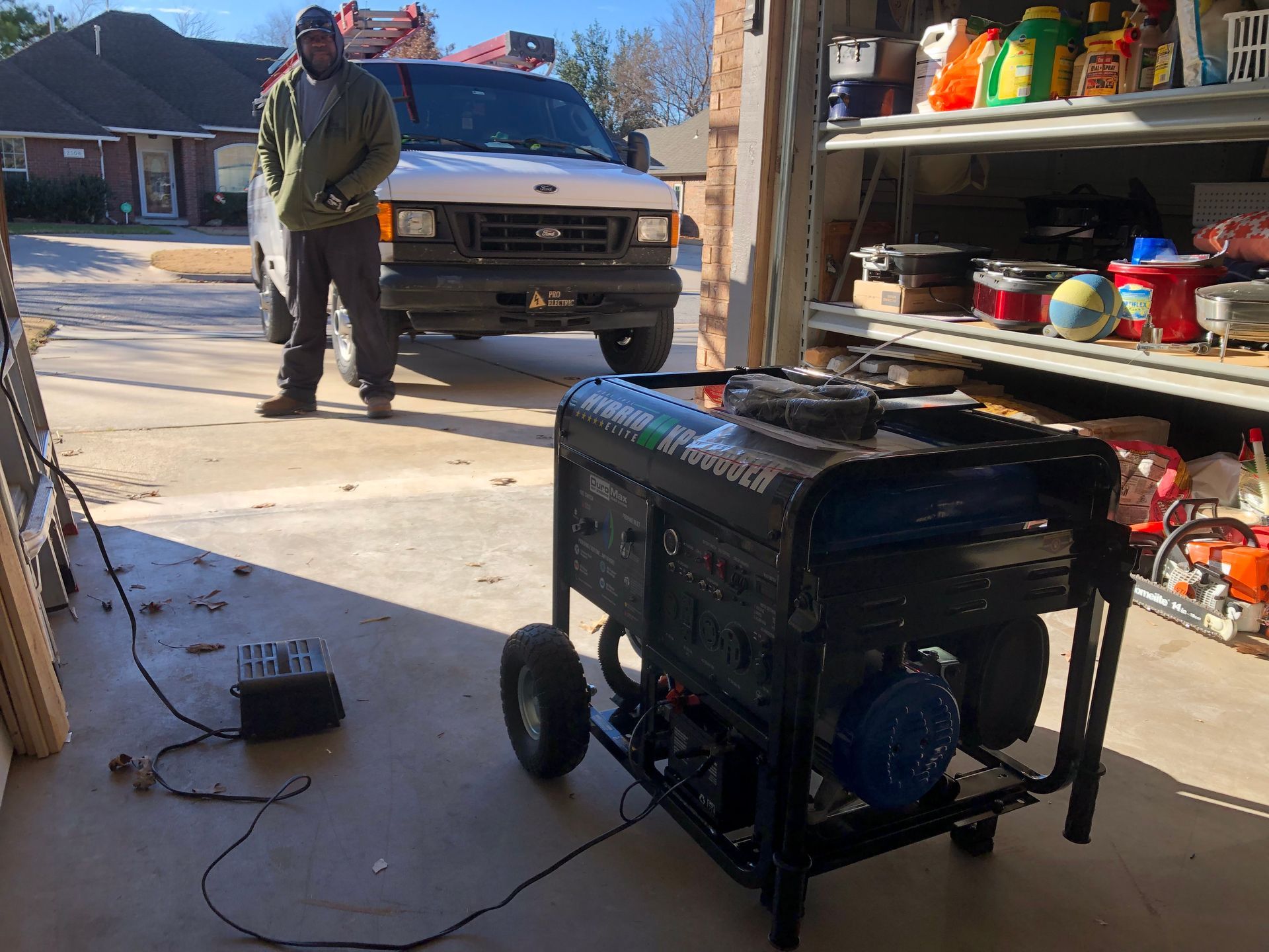 a man is standing next to a generator in a garage