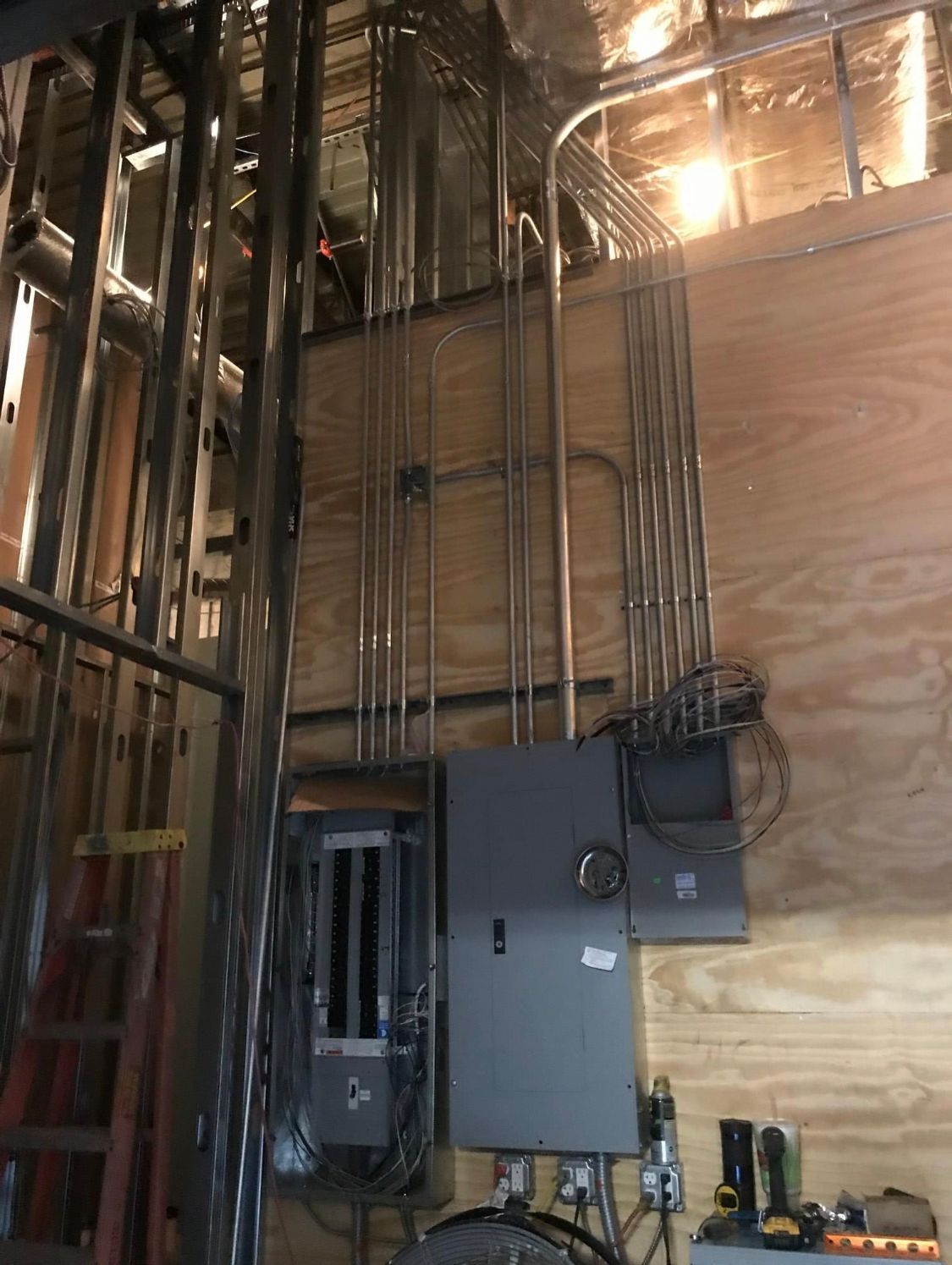 a building under construction with a lot of wires hanging from the ceiling