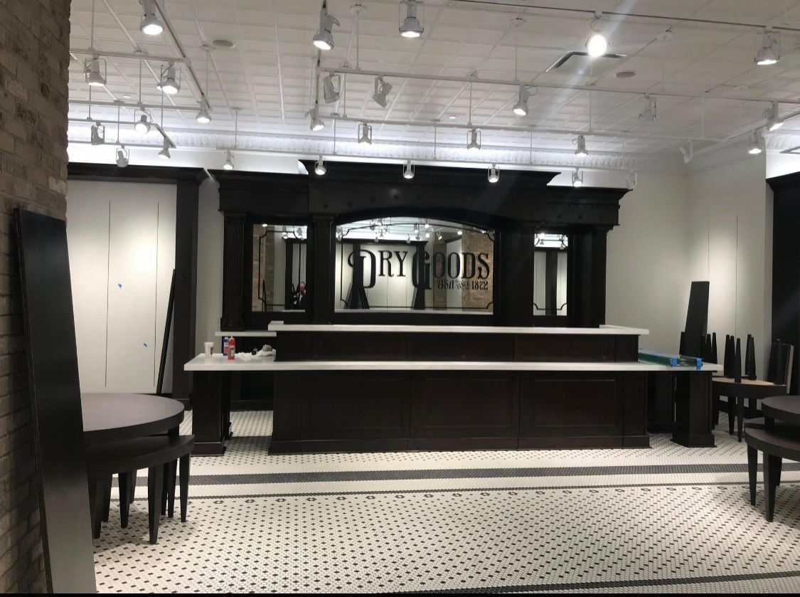 a large room with tables and chairs and a large counter