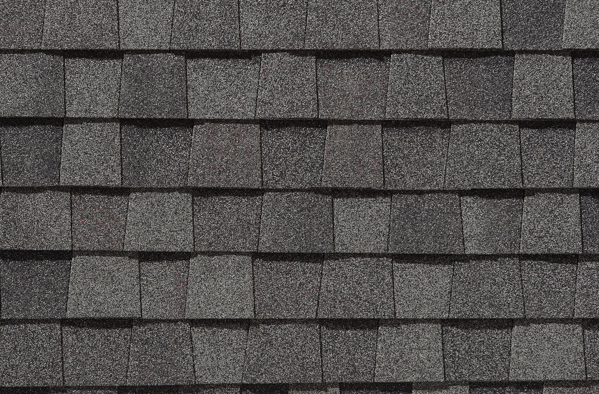 A close up of a row of gray shingles on a roof.