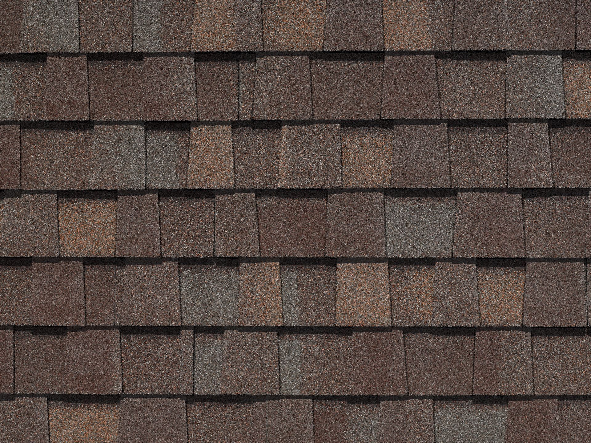 A close up of a roof with brown shingles.