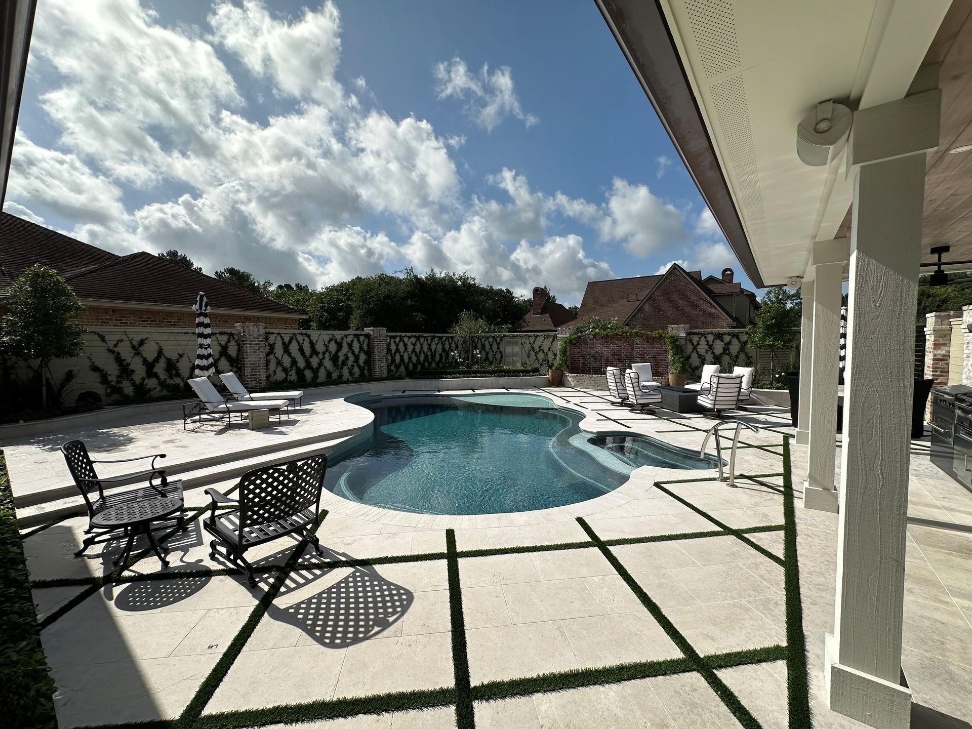 A large swimming pool in the backyard of a house