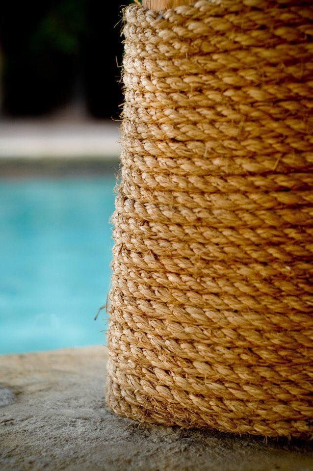 A close up of a rope sitting next to a pool.